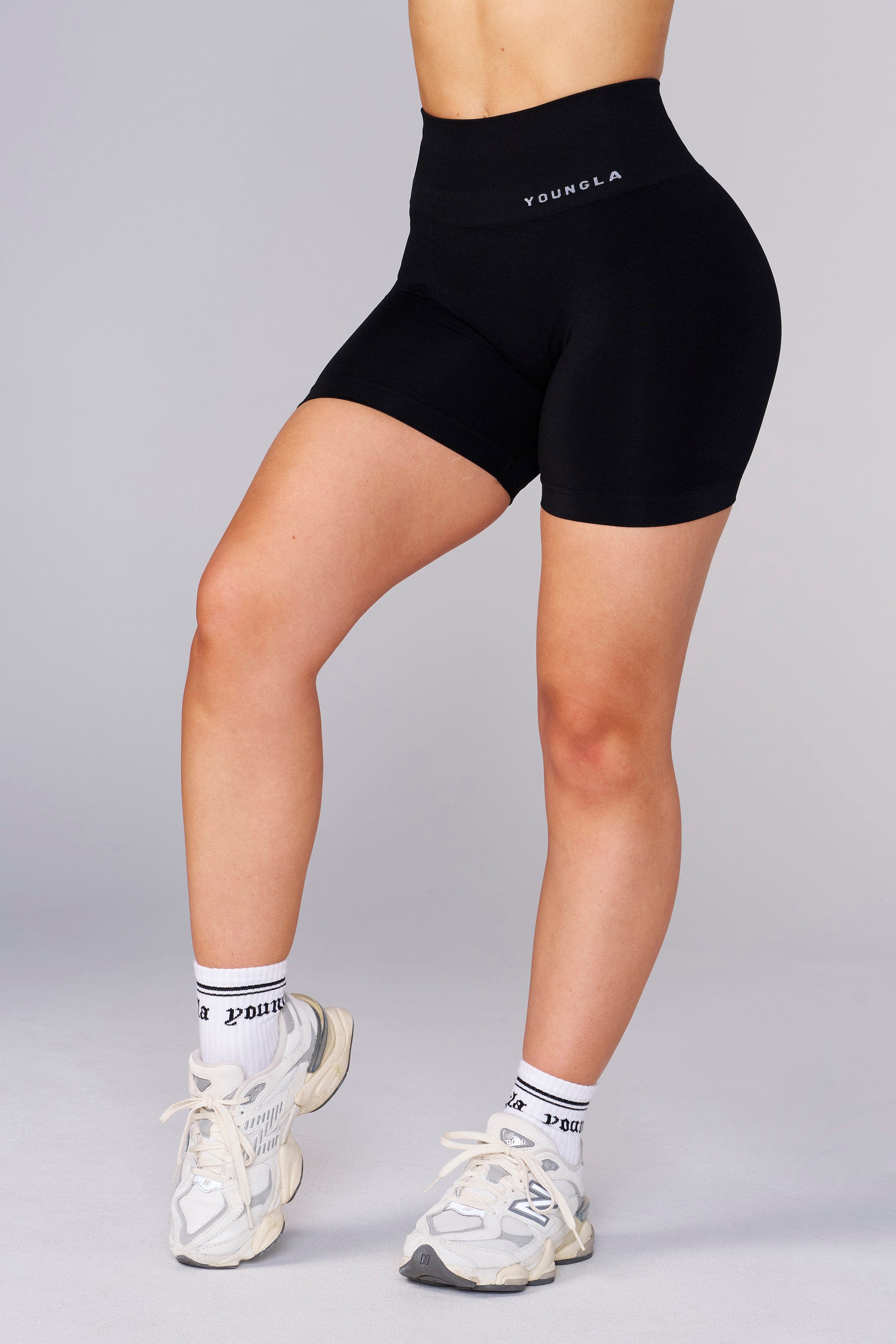 Model wearing seamless compression shorts during an outdoor workout.