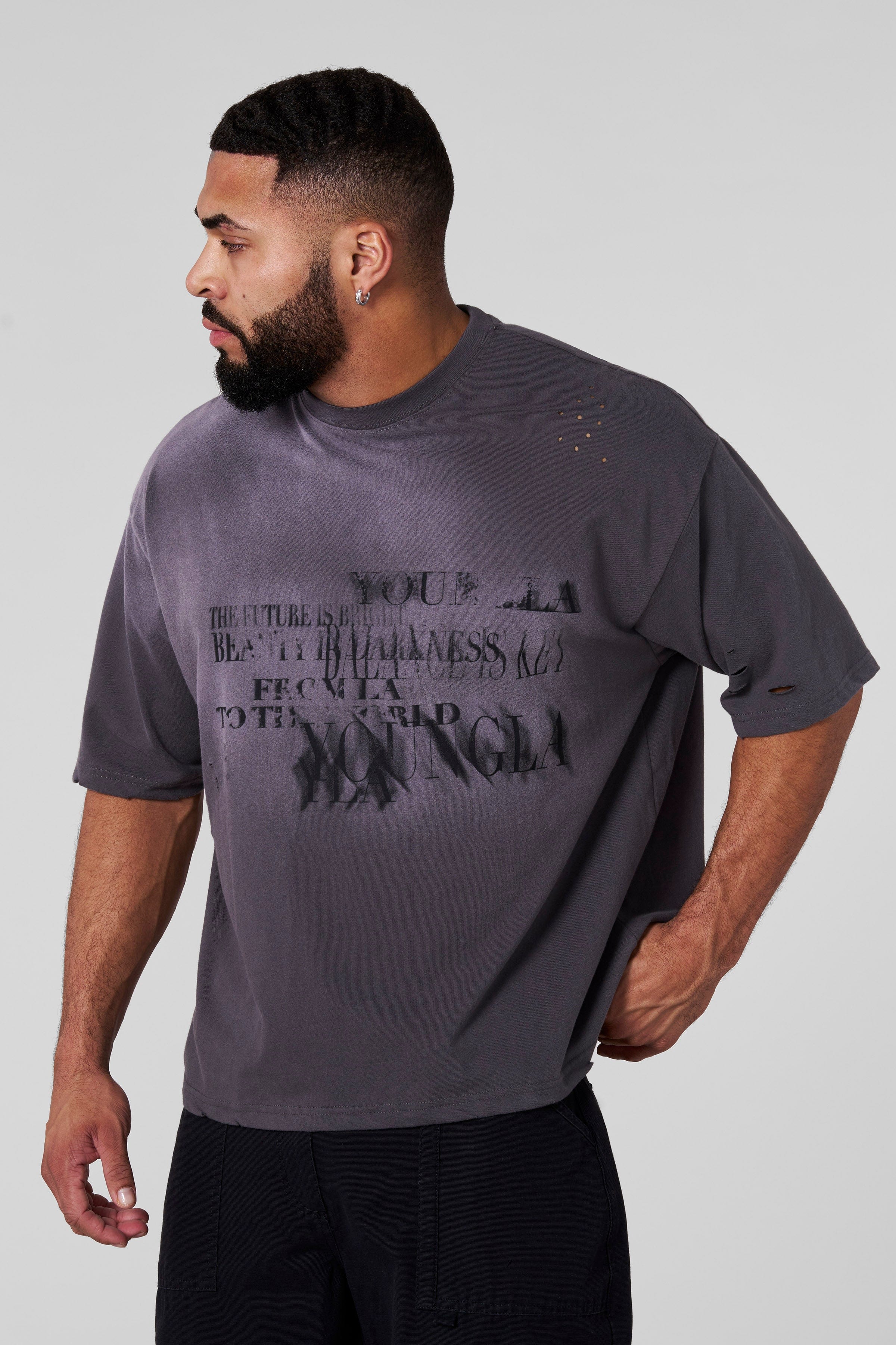 Close-up of illusion graphic print on oversized black tee