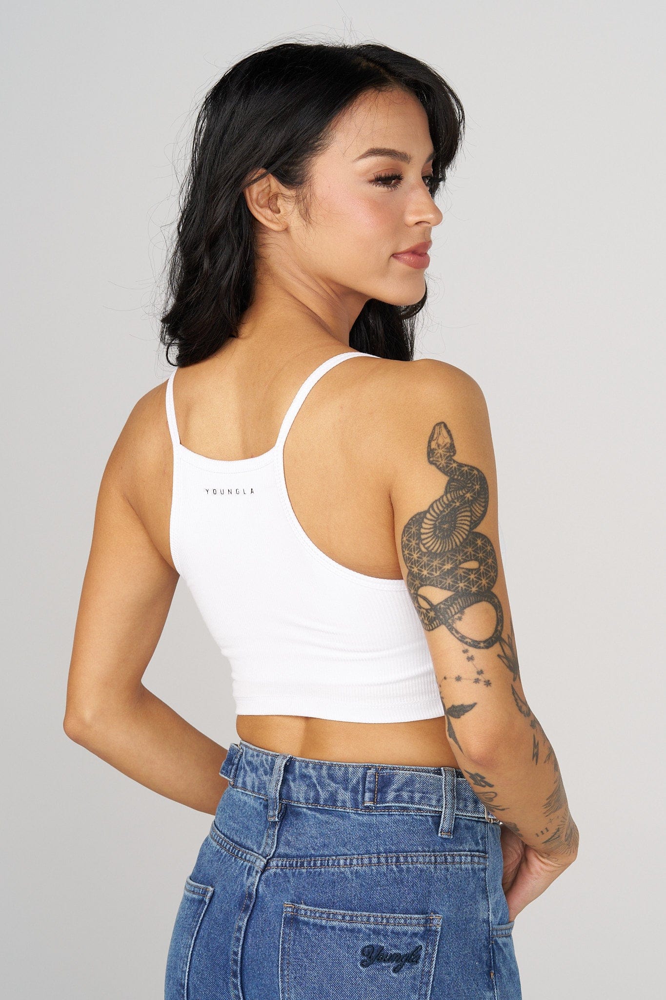 Front view of padded mens tank top with urban street background
