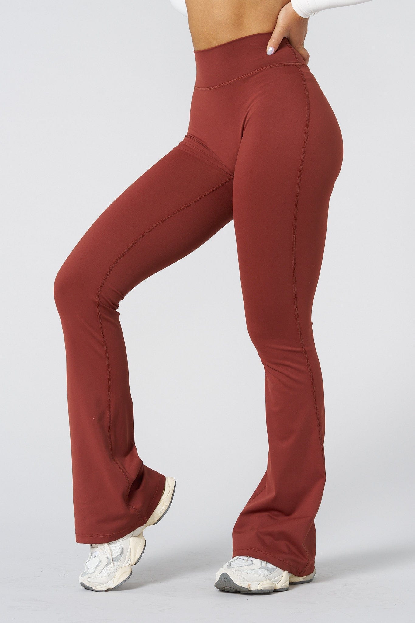 Close-up of high-waist grey flare leggings on a model