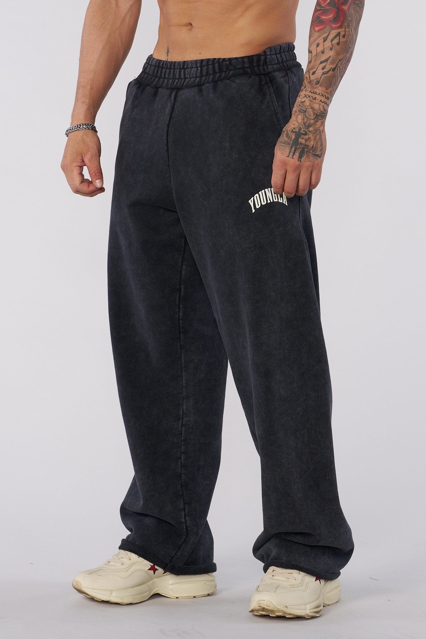 Side view of baggy sweat pants, highlighting the unique pigment-washed fabric.