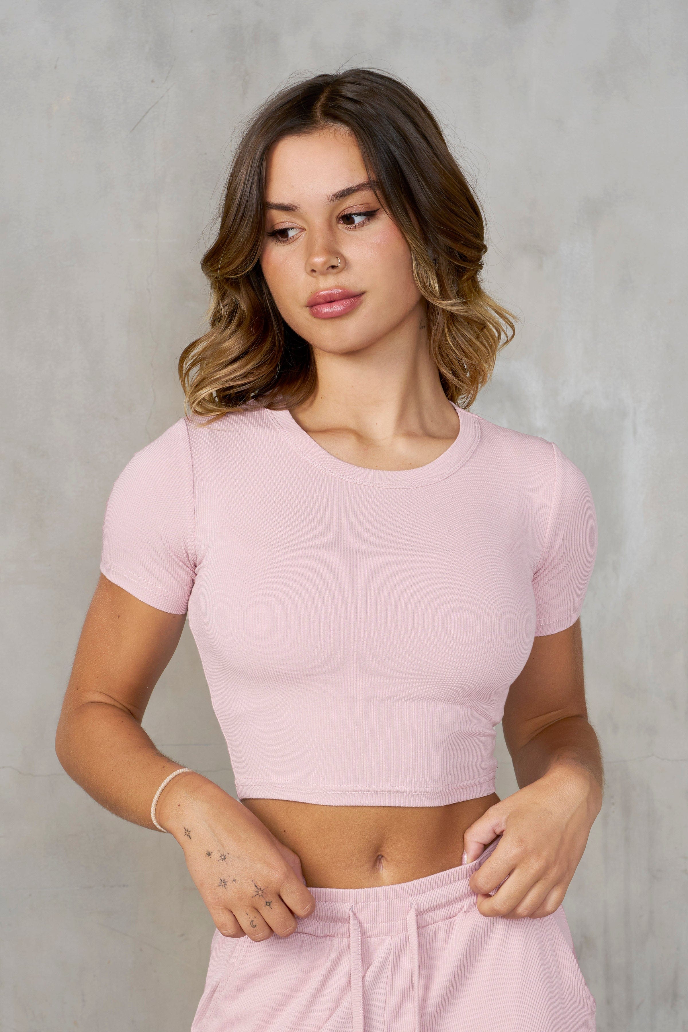 Side view of the baby tee paired with Ivy ribbed pants.