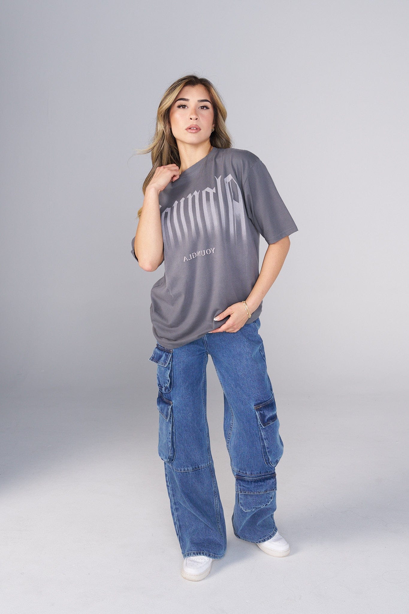 Model wearing the oversized T shirt with smoke print, paired with jeans for a relaxed look