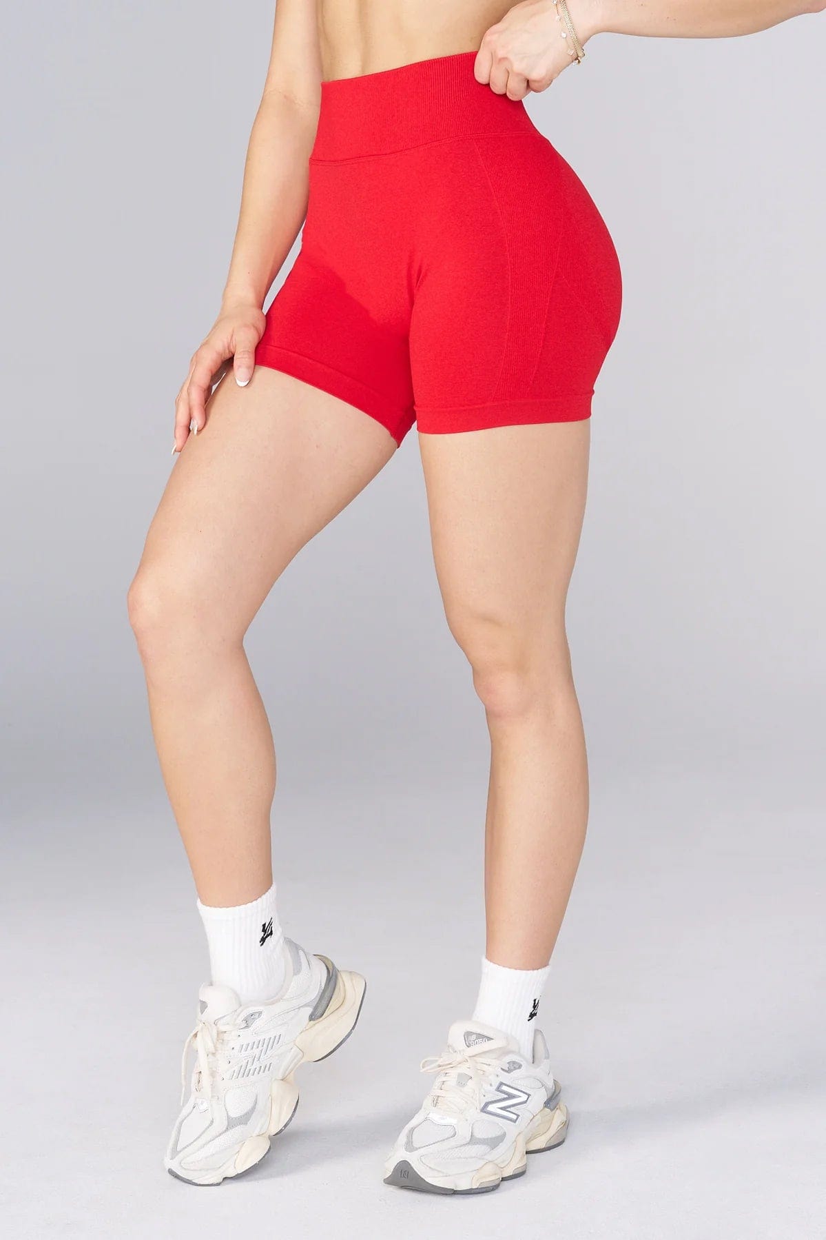 Front view of a model in hourglass workout shorts, showcasing the flattering fit.