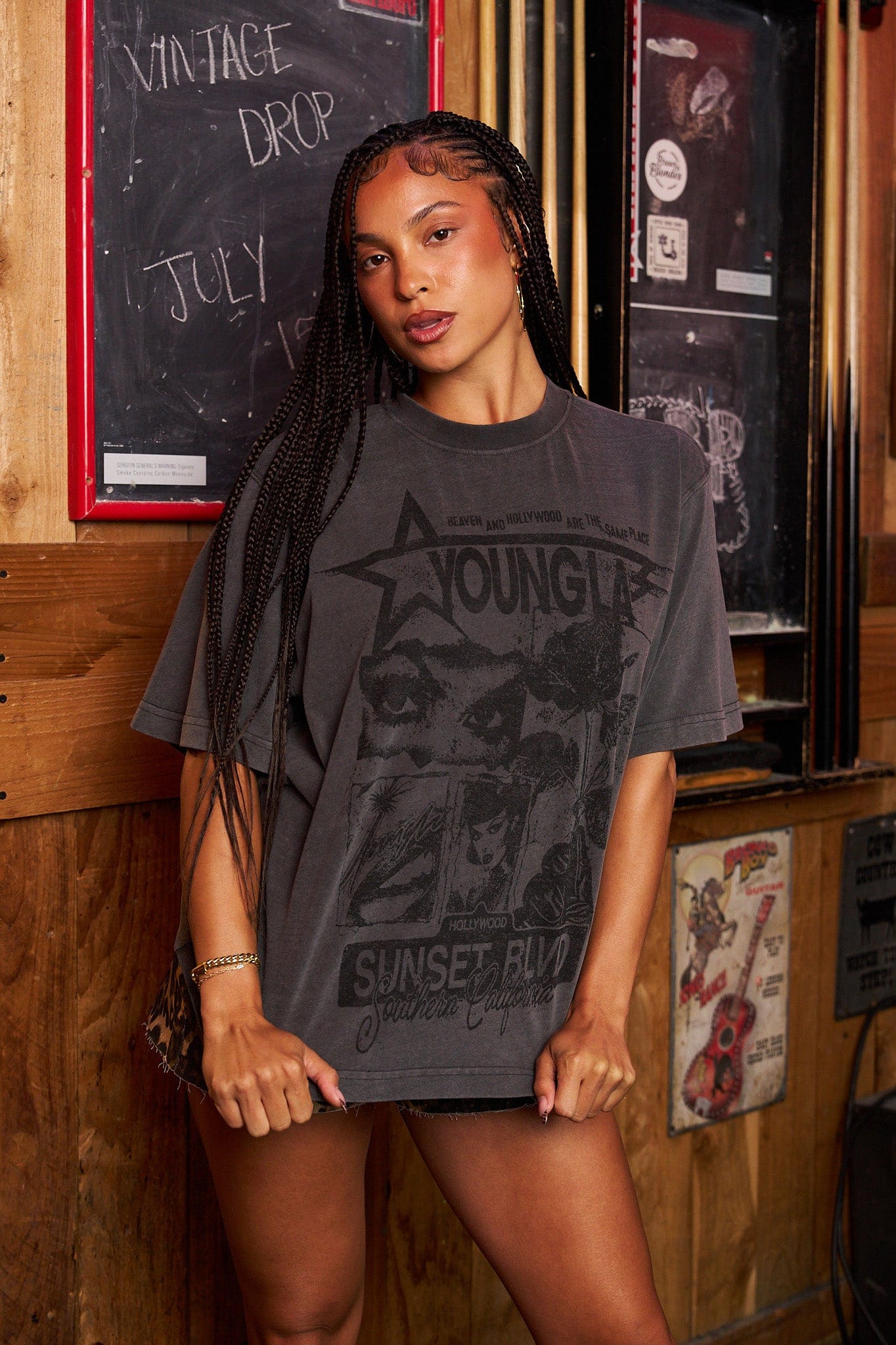 Flat lay of three oversized tees with distinct vintage-style prints
