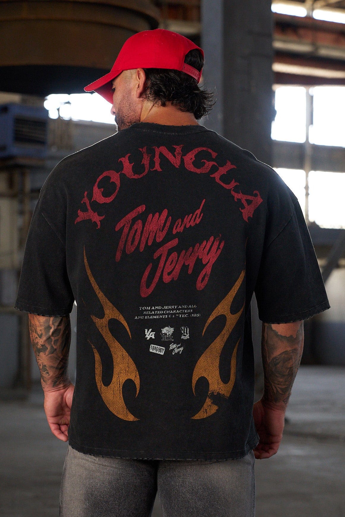 Model wearing oversized T shirt with nostalgic Tom & Jerry design in casual setting