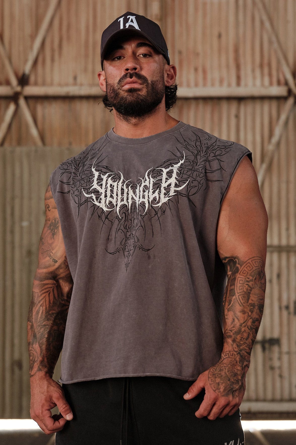 Close-up of the textured embroidery logo on the sleeveless shirt.