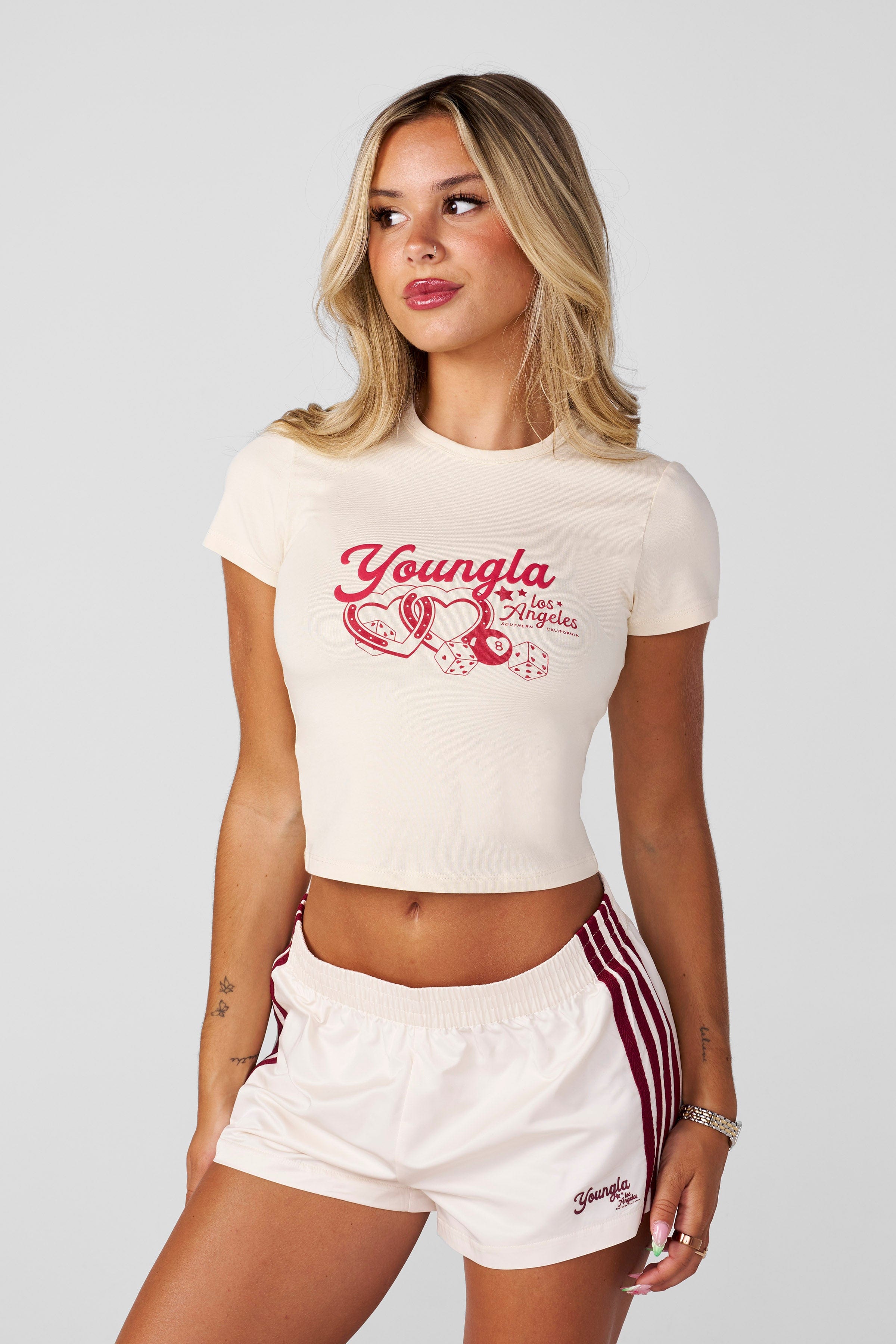 Vintage baby t-shirt folded on wooden shelf, showcasing retro graphic design