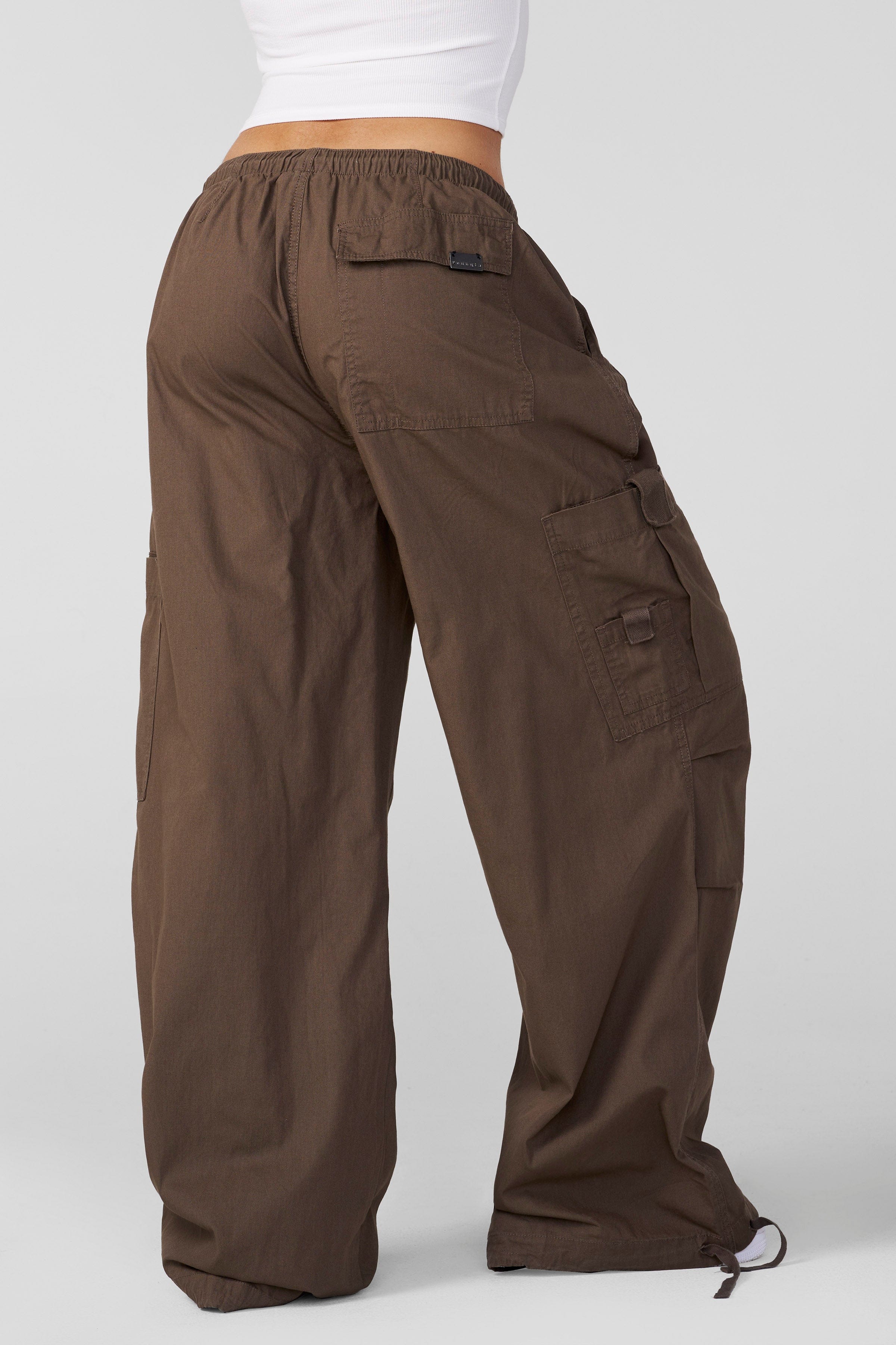 Side angle of oversized pants styled with boots for cold-weather wear
