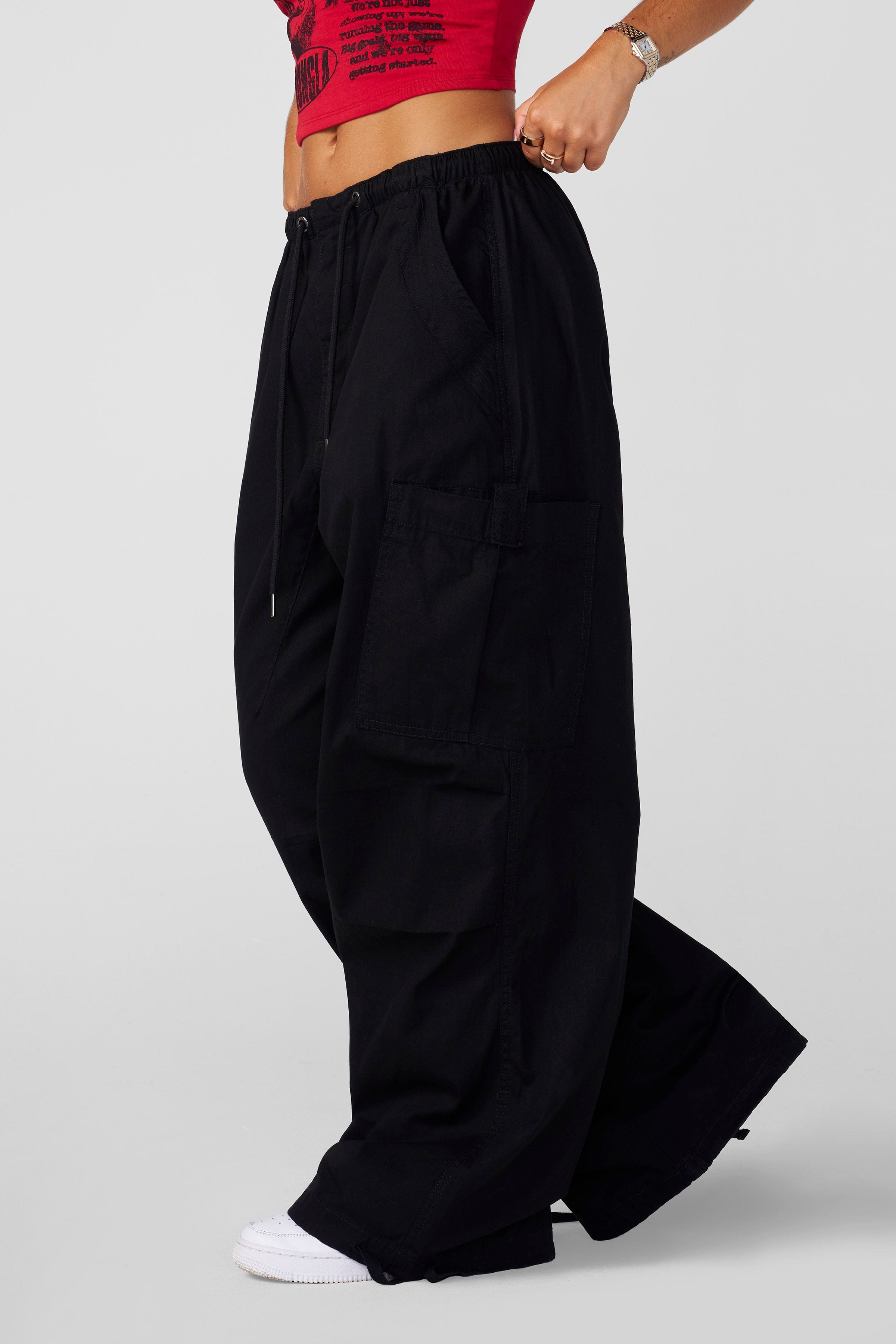 Front view of baggy cargo pants with drawstring waist and cuffed ankles