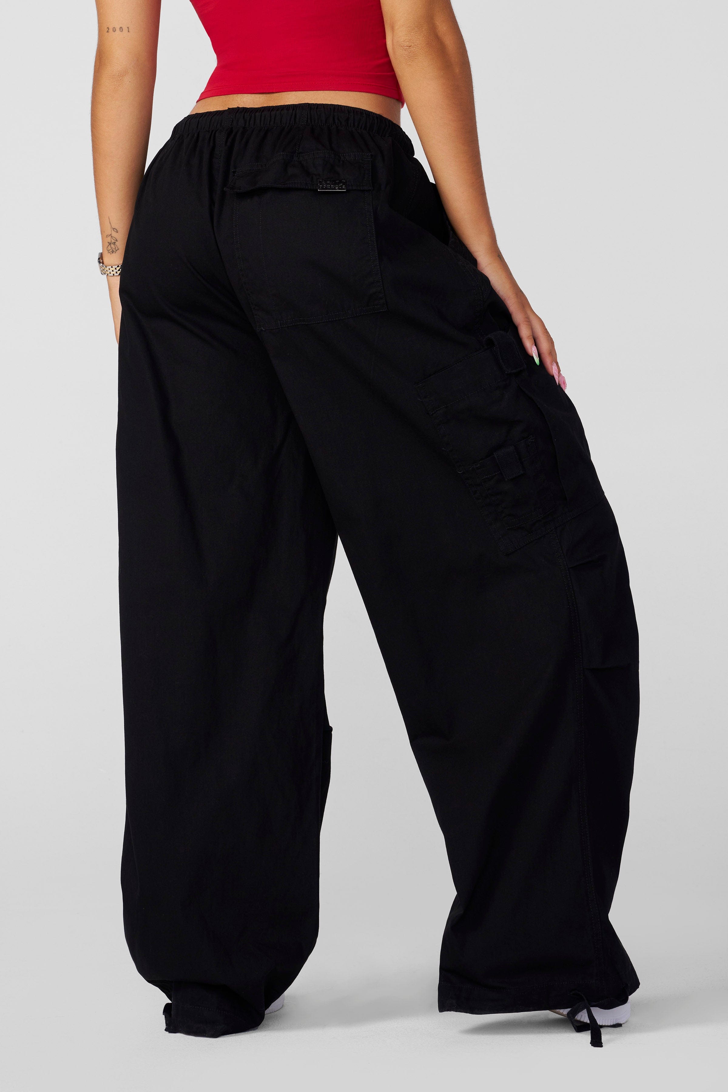 Side angle of oversized pants styled with boots for cold-weather wear
