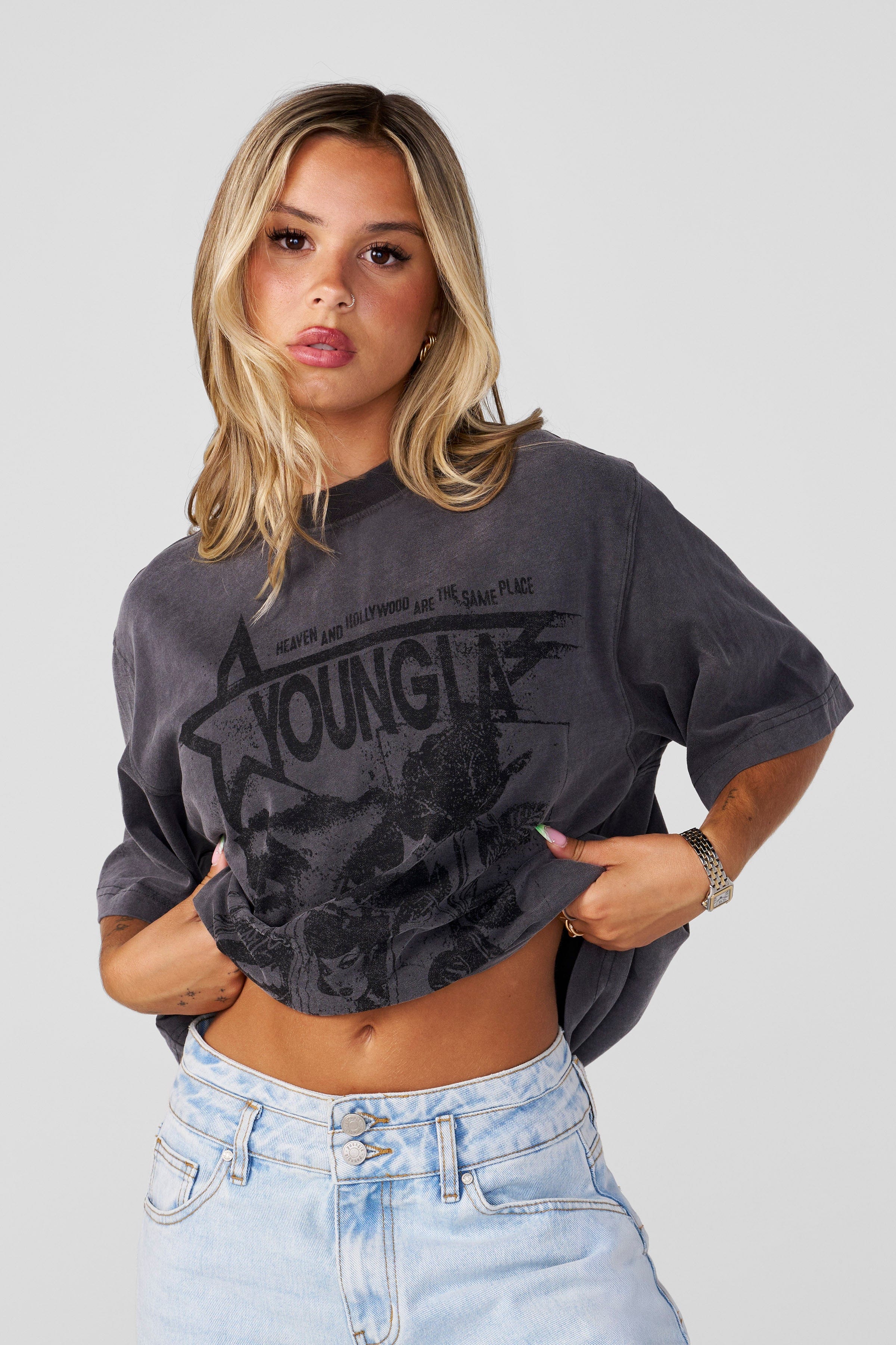Flat lay of three oversized tees with distinct vintage-style prints