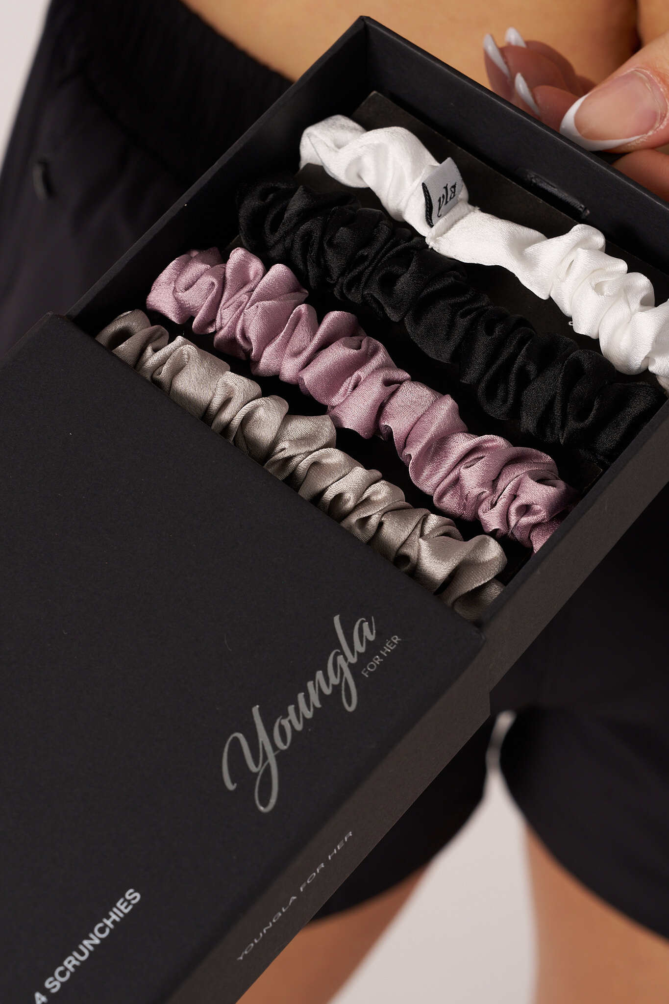 Elegant satin scrunchies displayed in neutral colors, ideal for hair styling.
