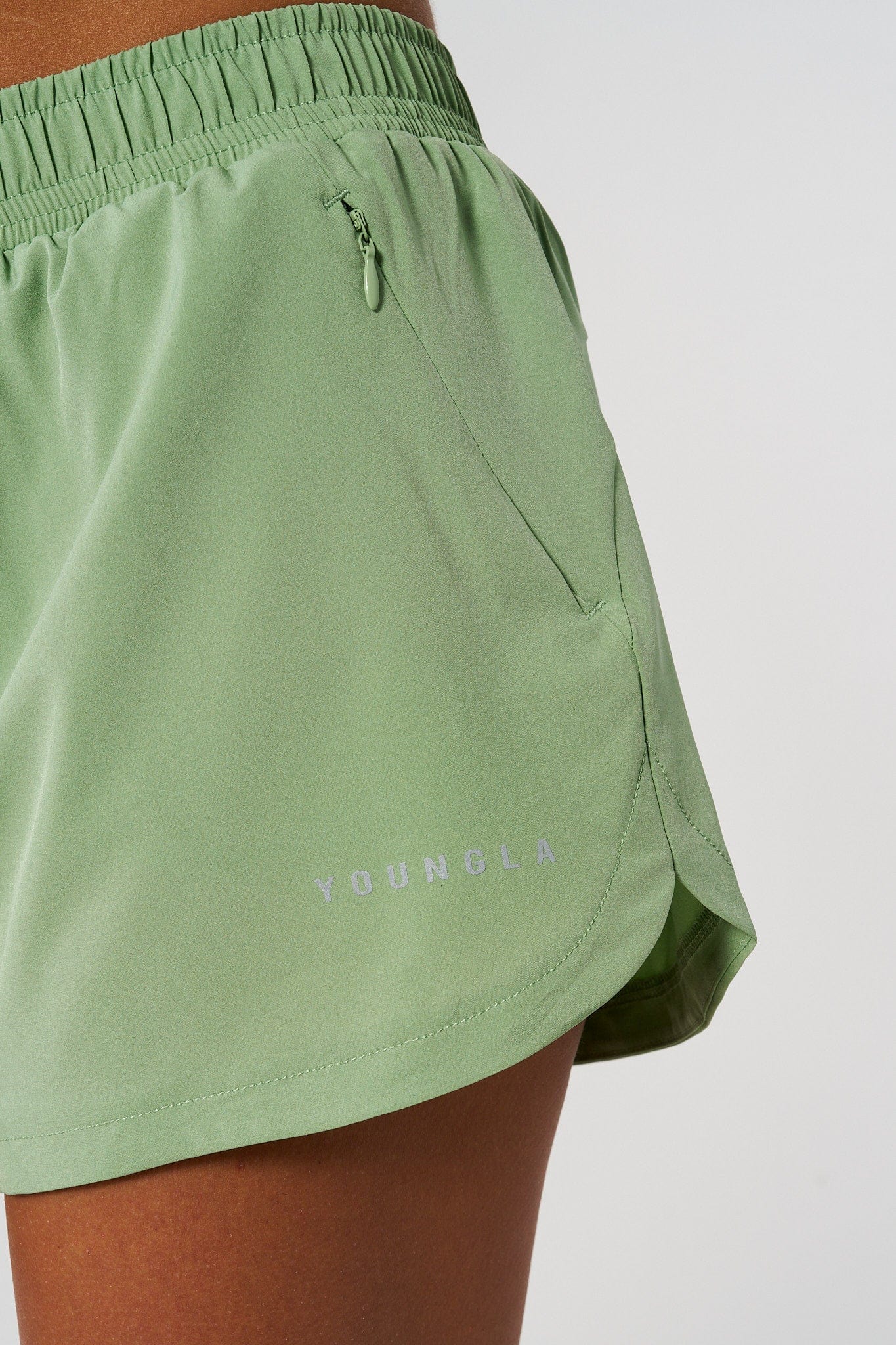 Side view of mens running shorts showing waist-adjust puller