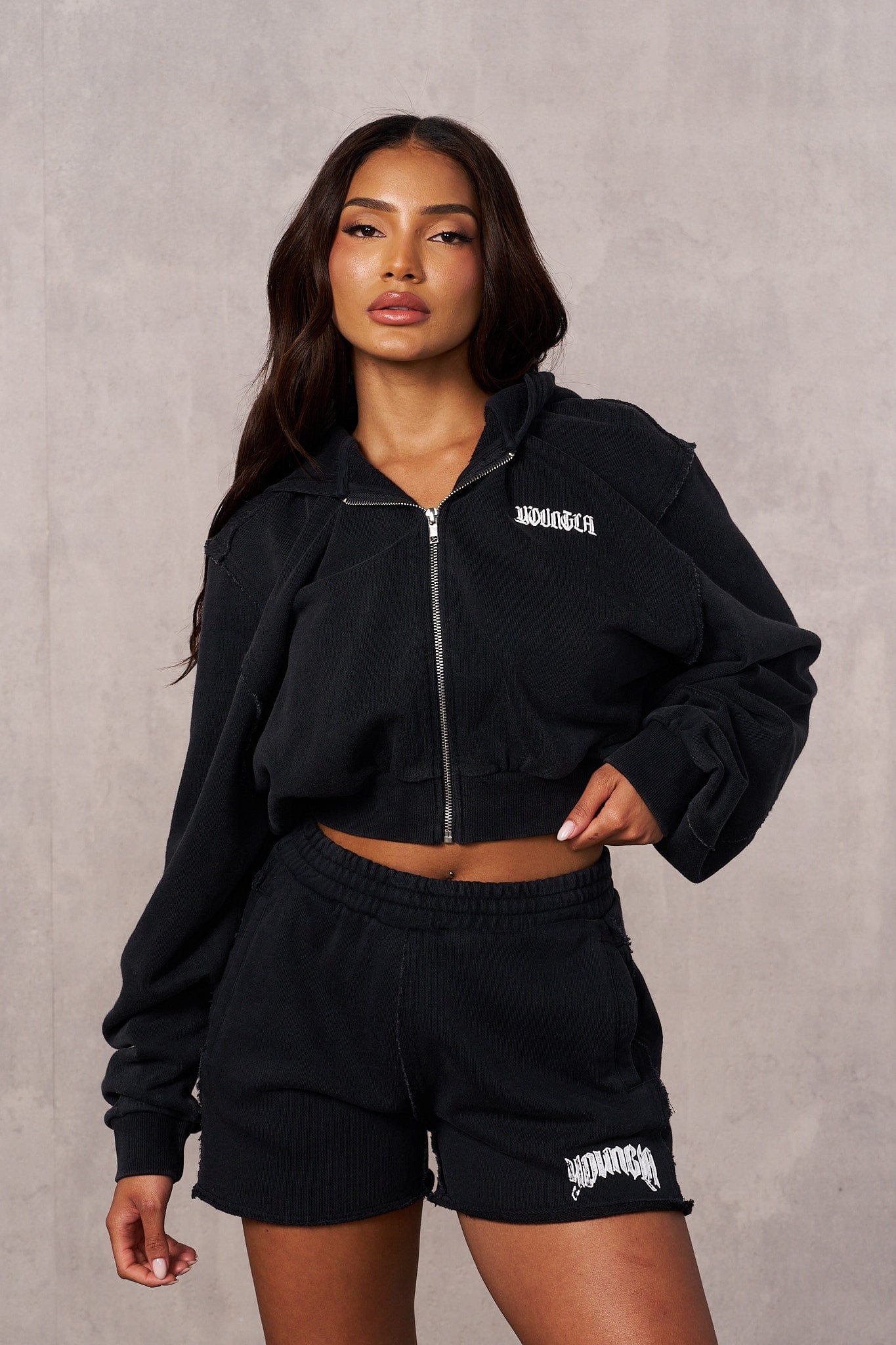 Side view showing cropped hoodie length and relaxed fit