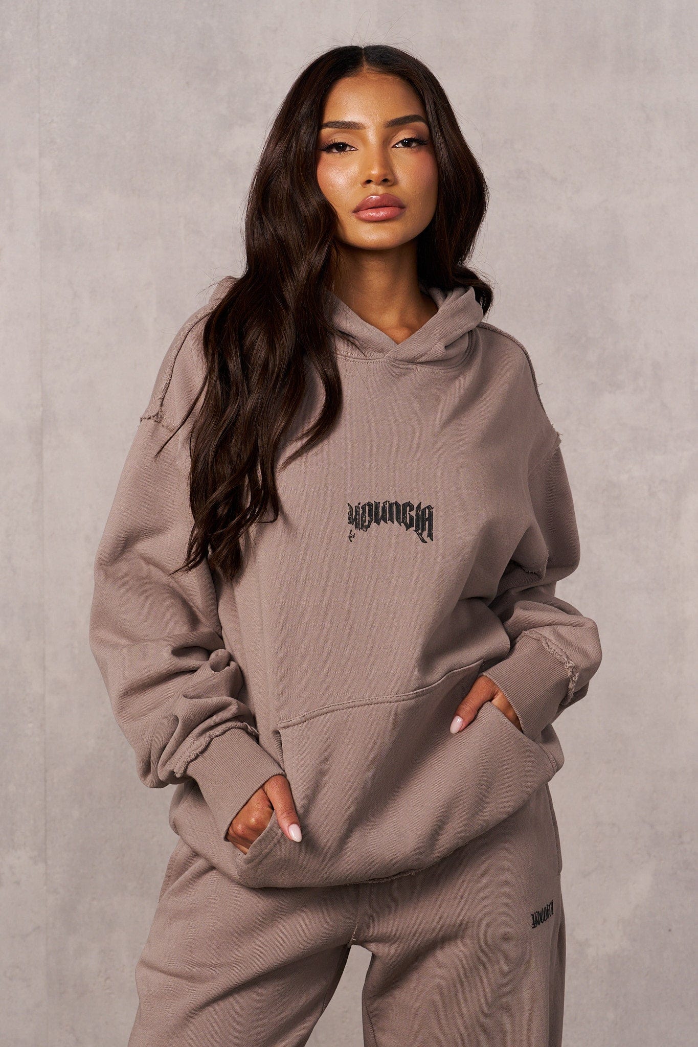Rebel Oversized Hoodie front view with earthy tone and logo detail