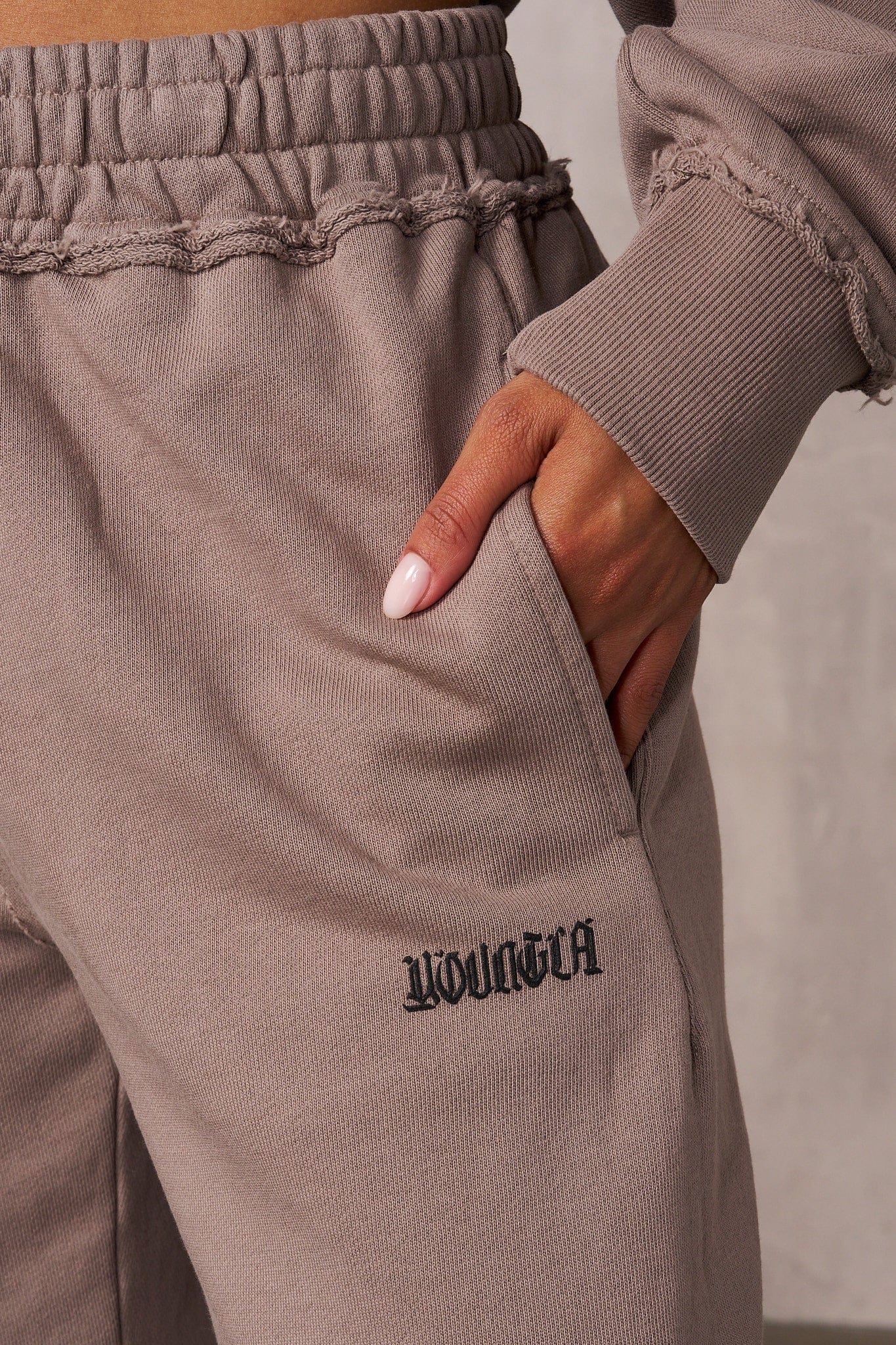 Close-up of the thick waistband and raw edge hems of the Rebel Edge joggers.