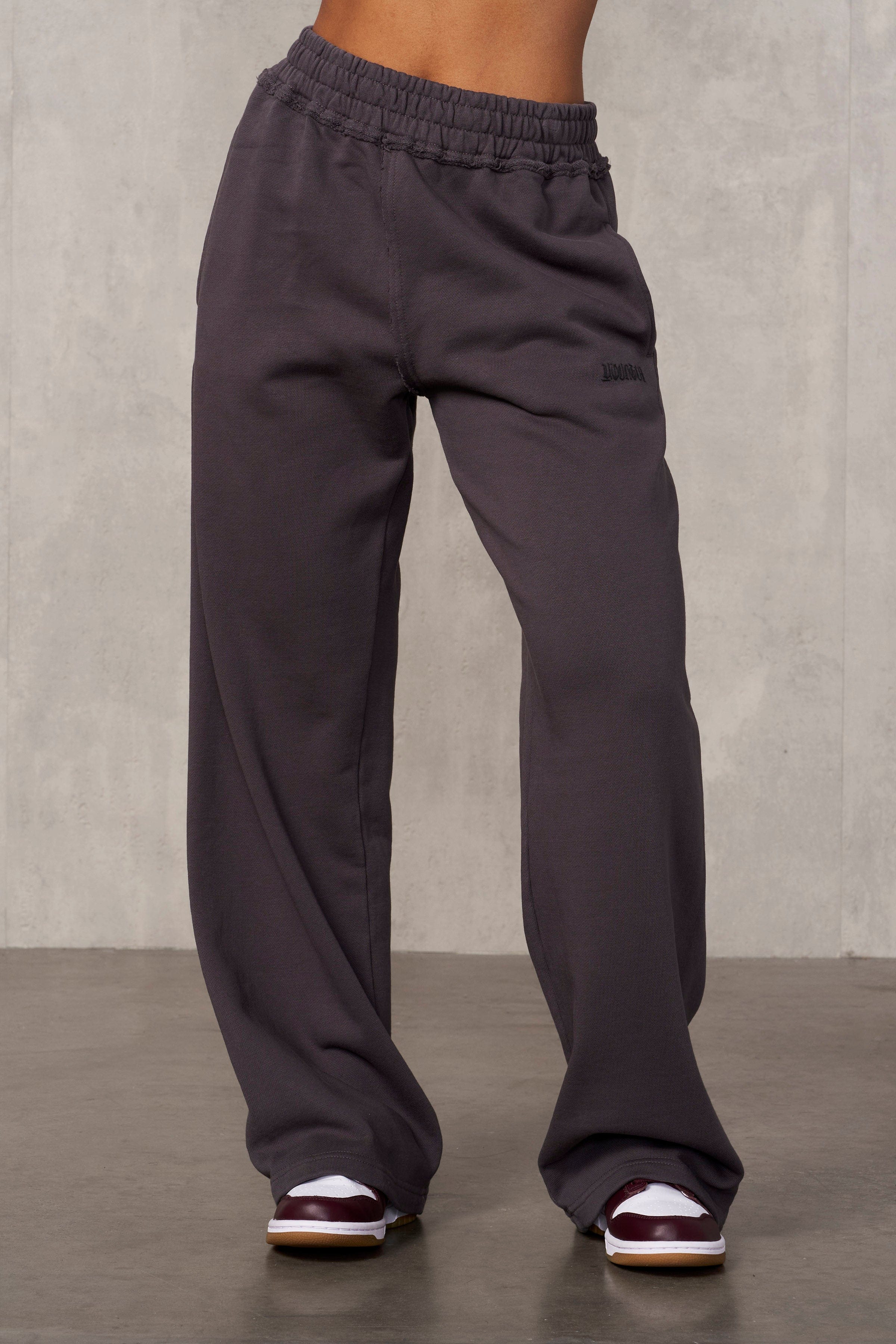 Rebel Edge black joggers displayed against a city backdrop, showcasing their oversized fit.