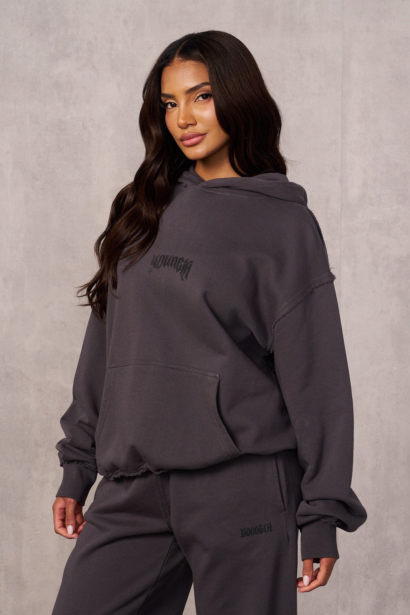 Streetwear outfit pairing the hoodie with black jeans and sneakers