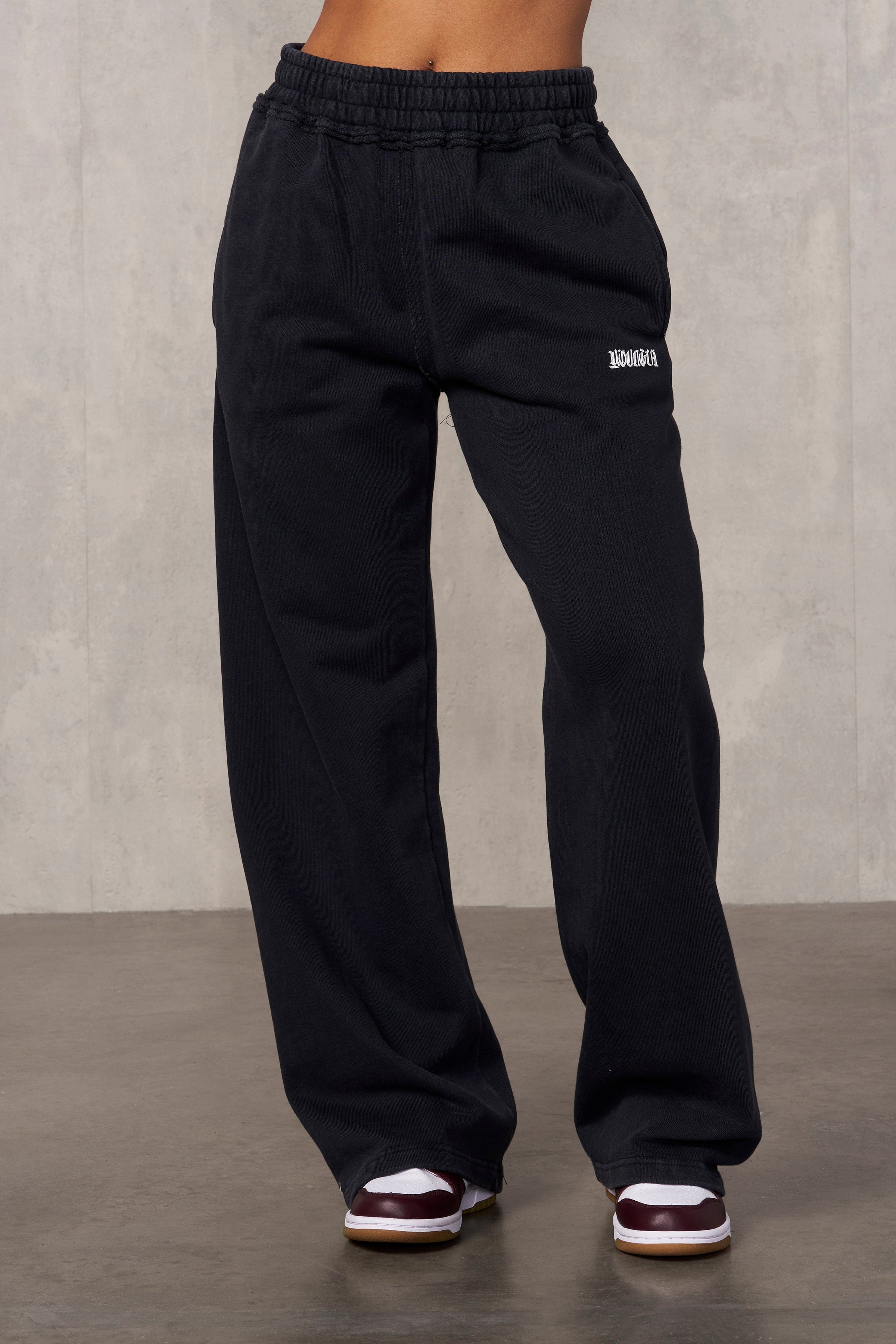 Close-up of the thick waistband and raw edge hems of the Rebel Edge joggers.