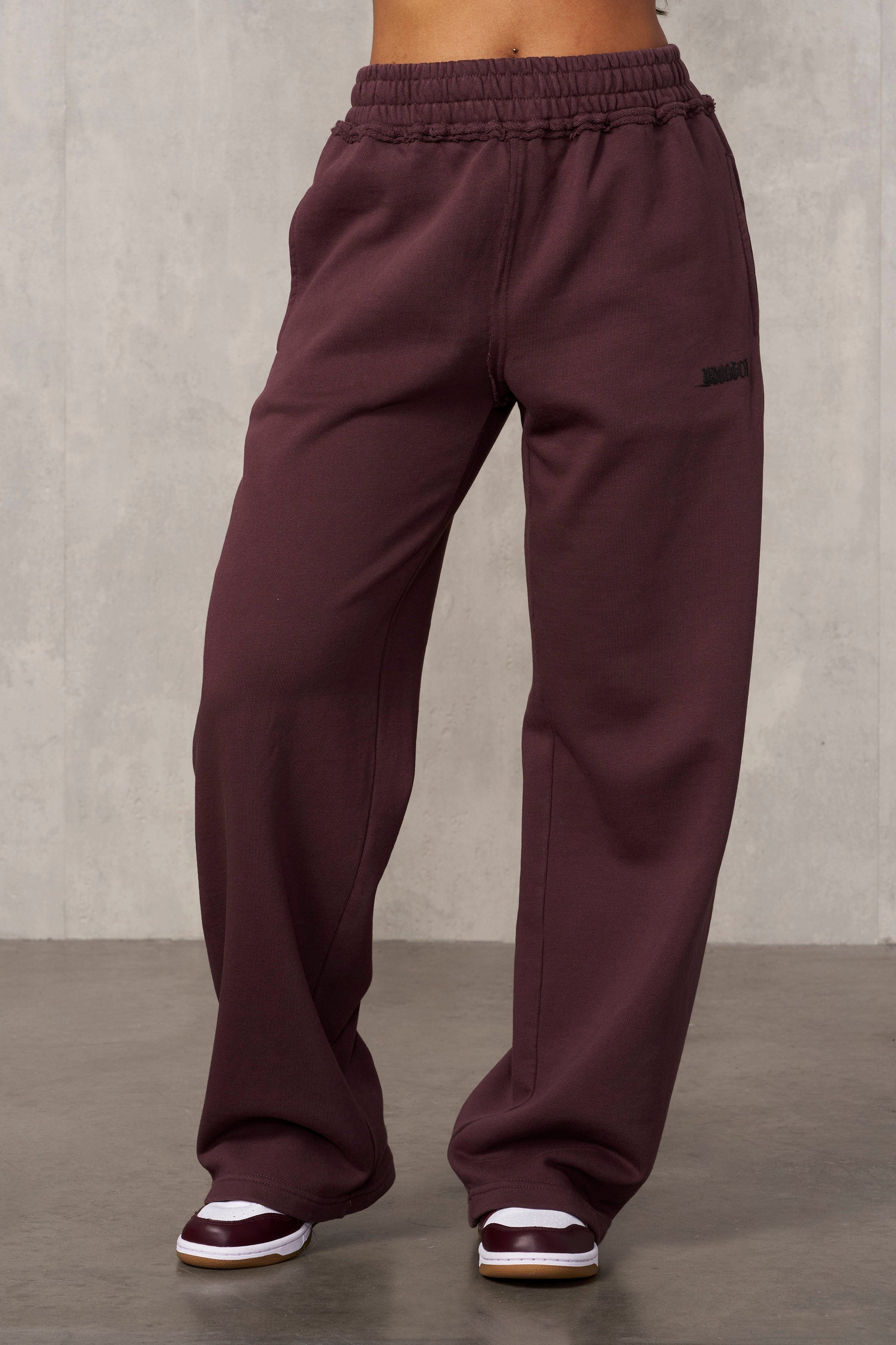 Close-up of the thick waistband and raw edge hems of the Rebel Edge joggers.