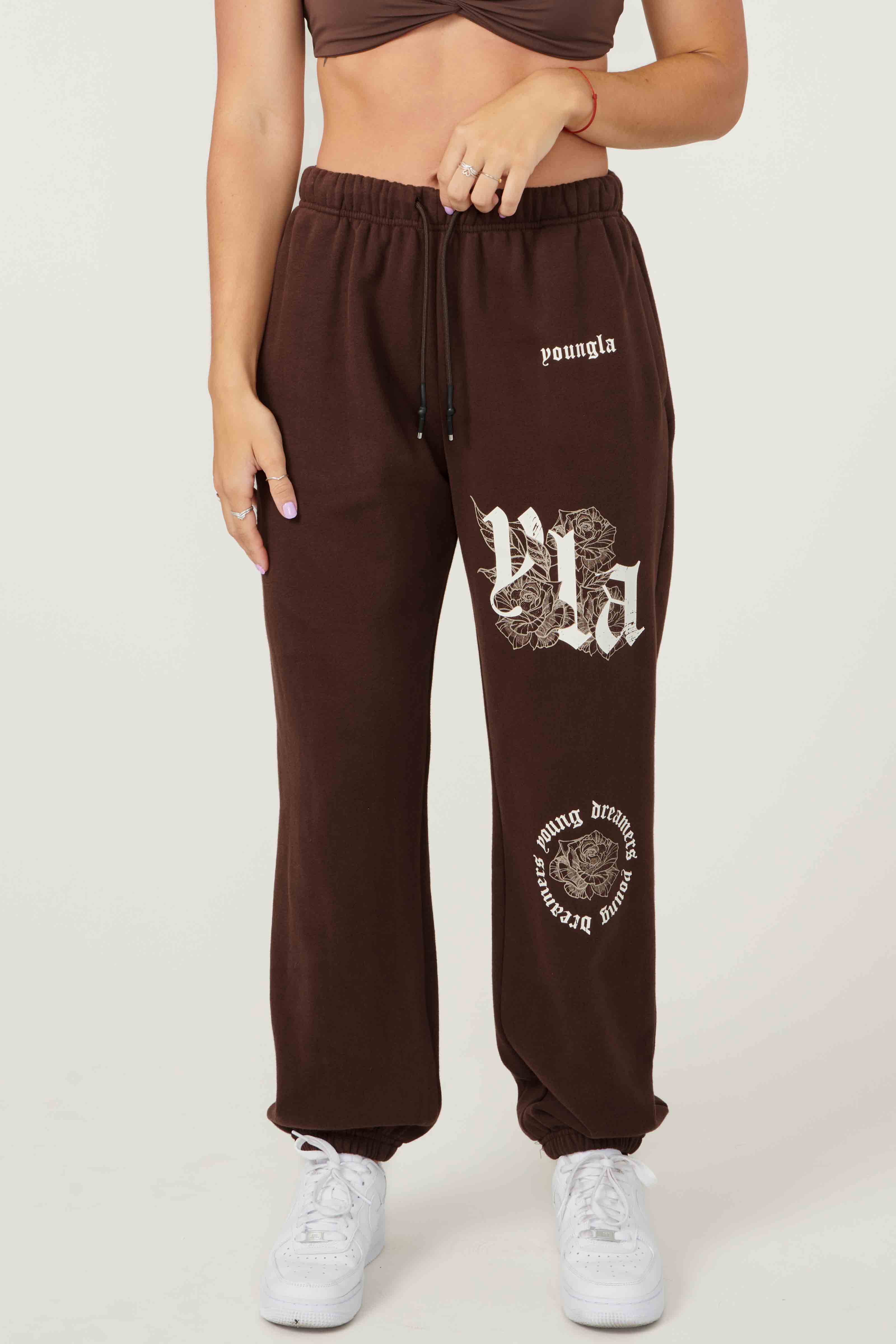 Close-up of rose print and vintage YLA logo on joggers for women
