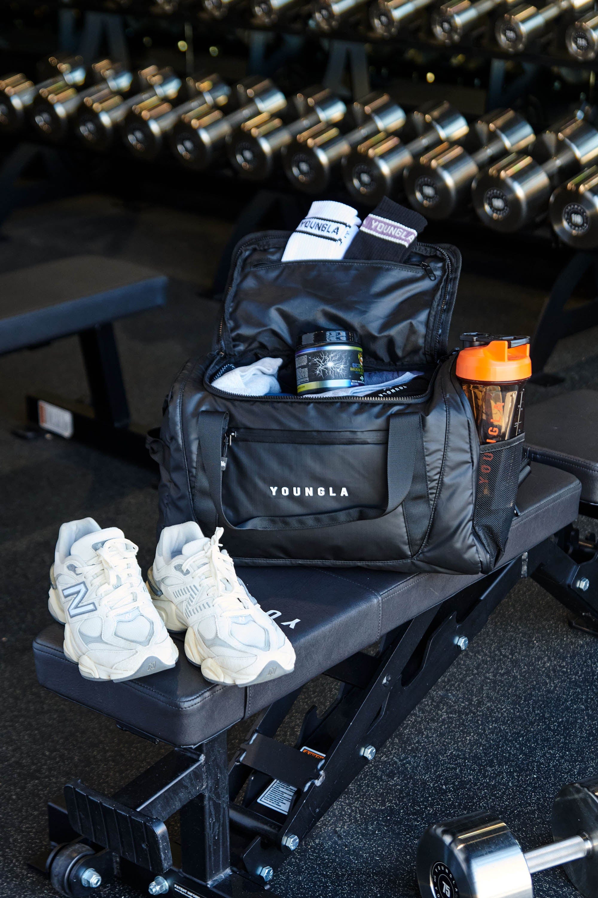Side profile showcasing mesh bottle pockets and reinforced carry handles of this versatile travel bag.