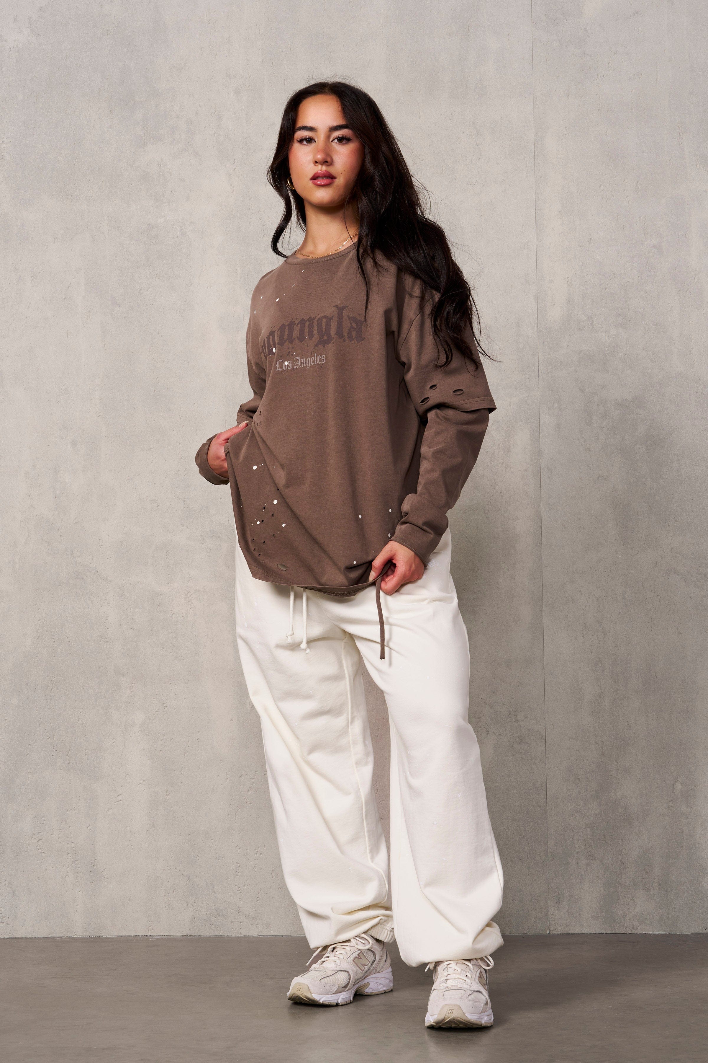 Front view of Ravage distressed joggers on a model, showcasing oversized fit and streetwear style.