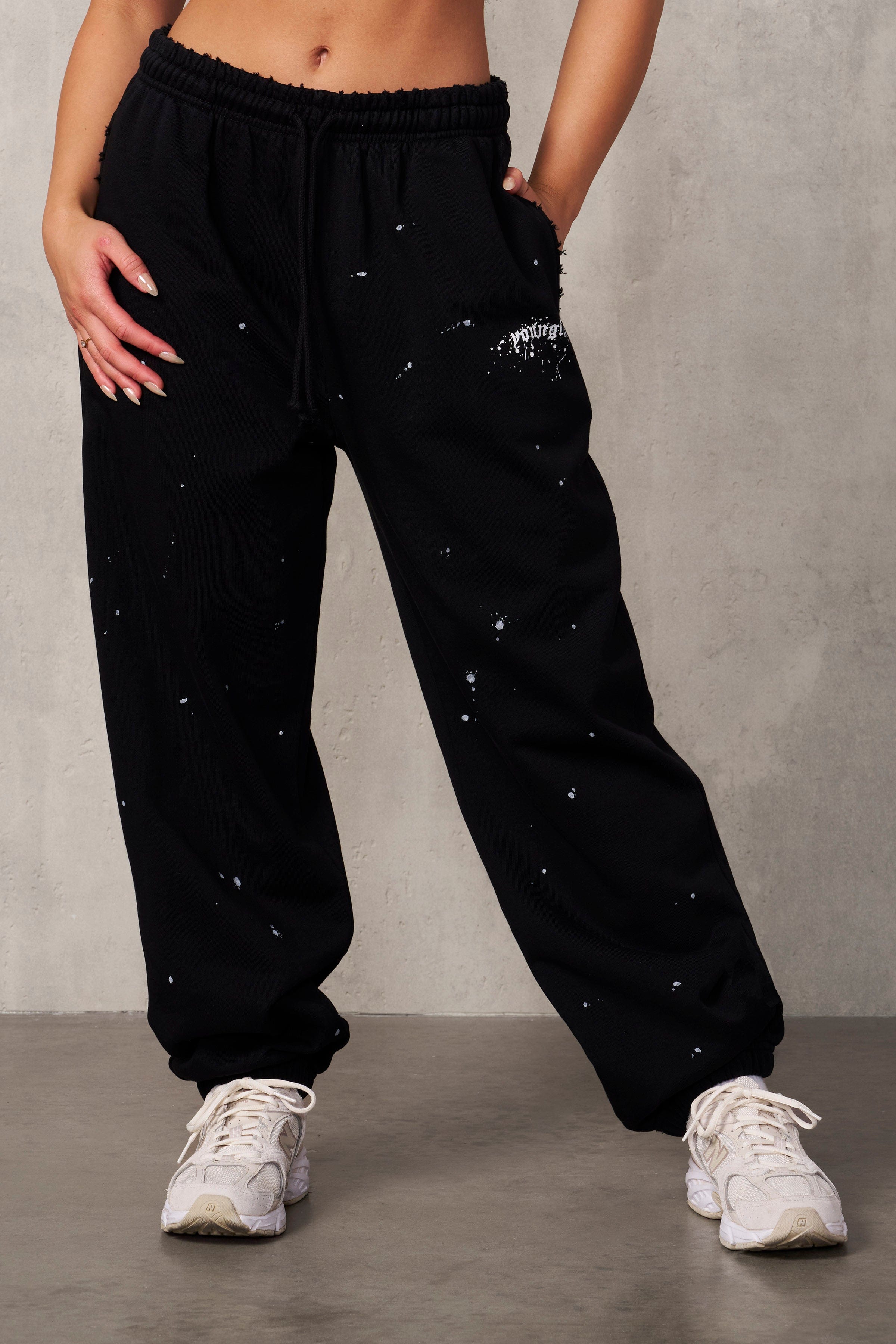 Front view of Ravage distressed joggers on a model, showcasing oversized fit and streetwear style.