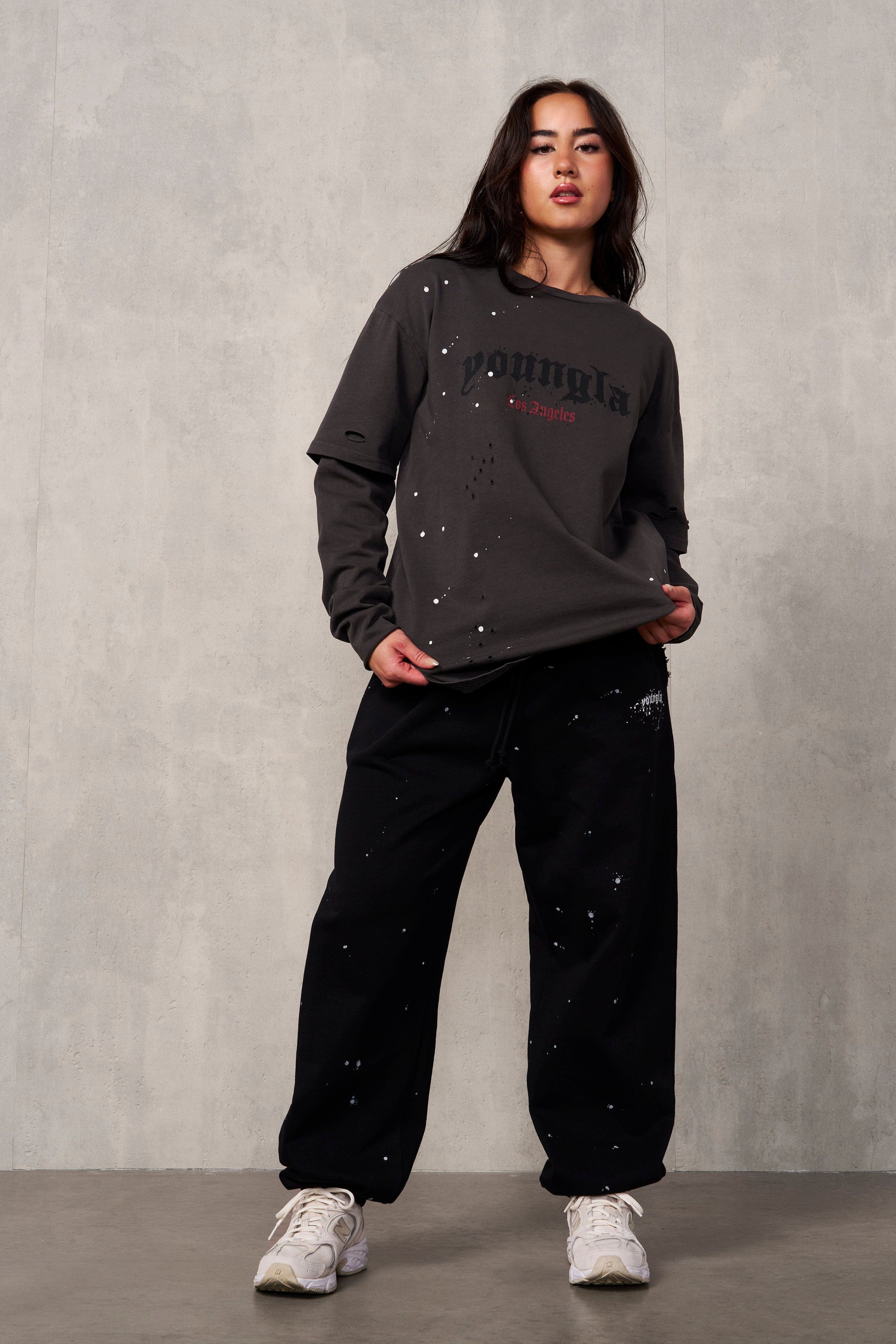 Front view of Ravage distressed joggers on a model, showcasing oversized fit and streetwear style.