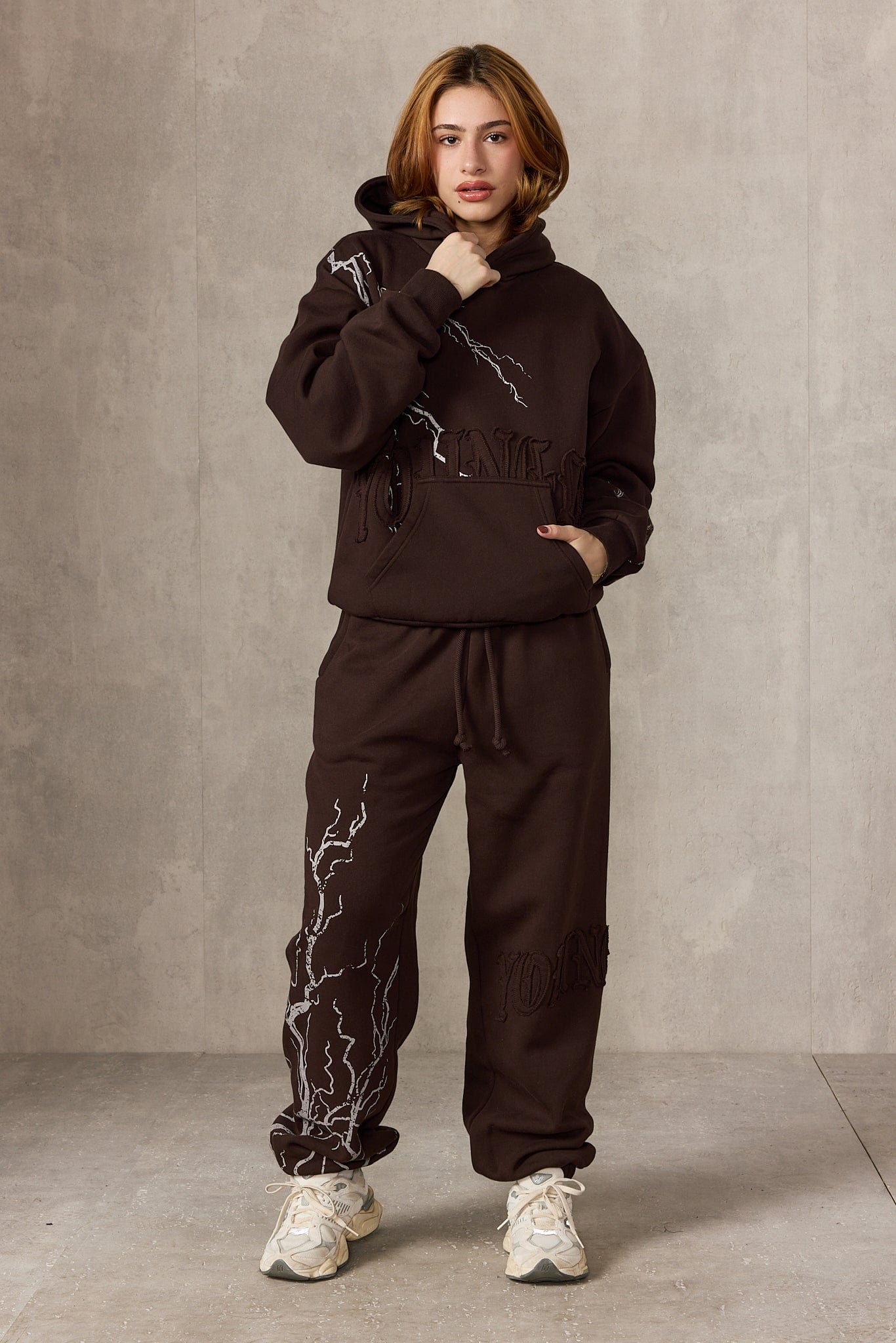 Back view showing the hoodies patchwork logo, perfect for streetwear outfits