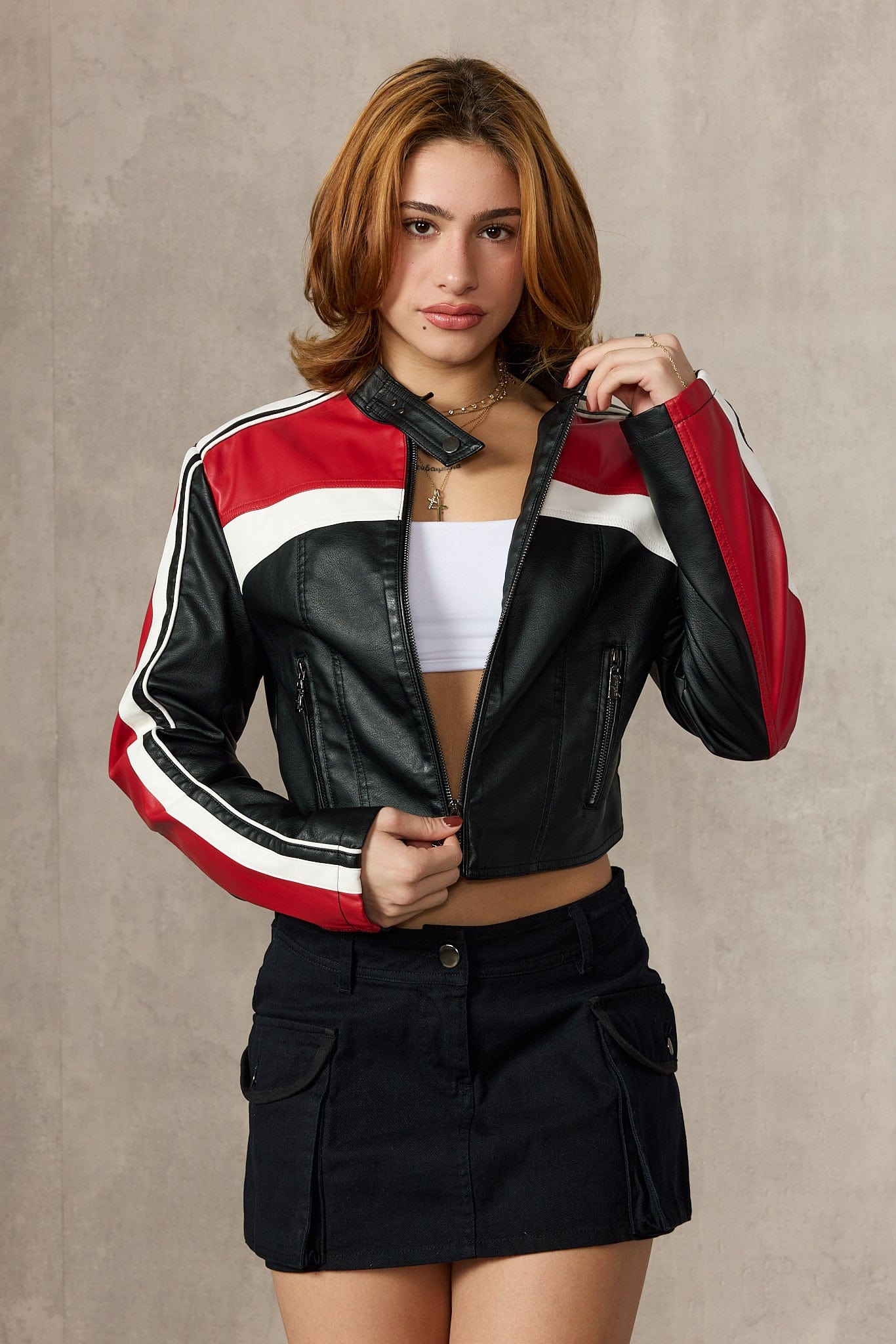 Urban shot of vintage racing jacket paired with high-waisted jeans