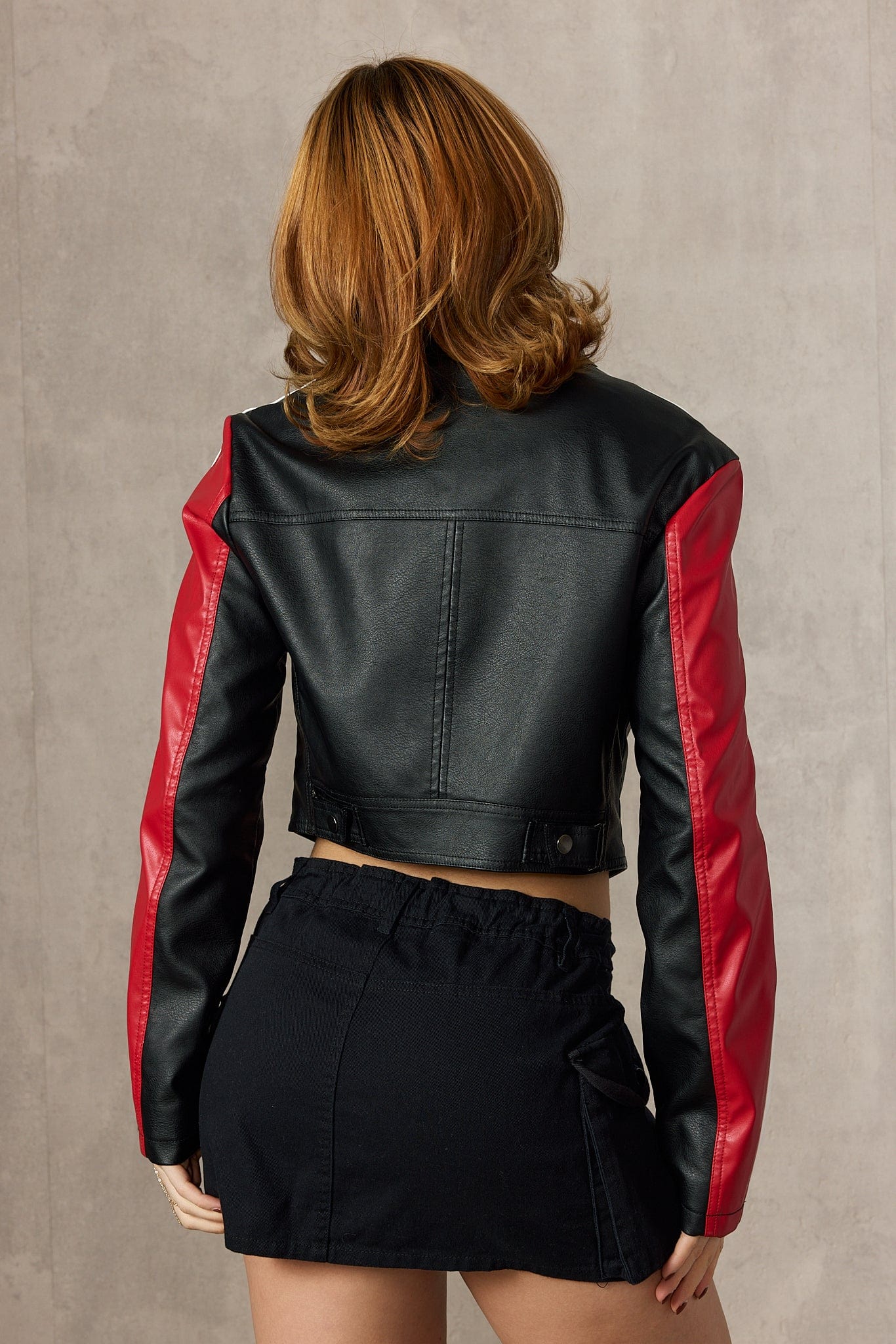 Side angle highlighting leather racing jacket silhouette and contours