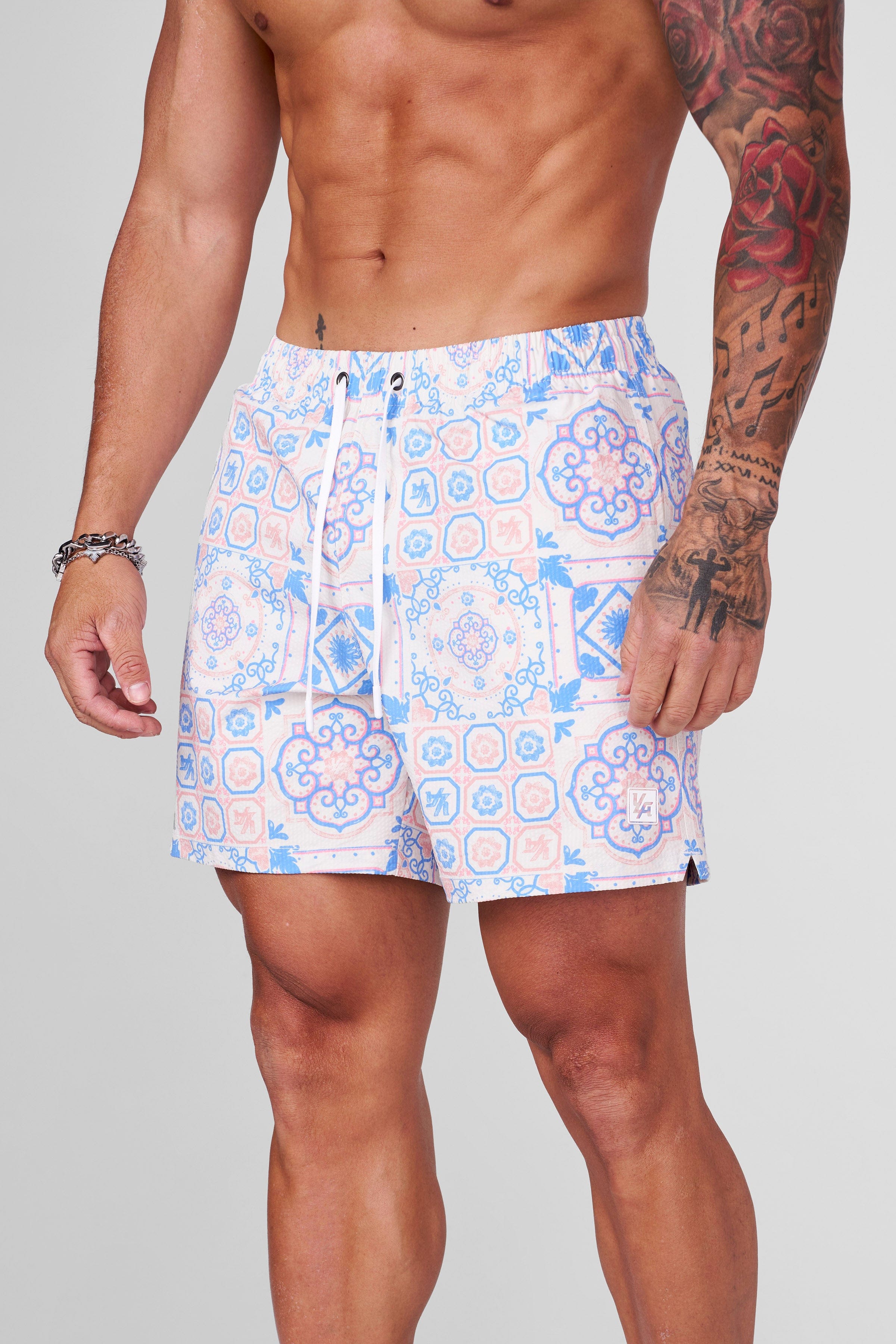 Front view of mosaic swim shorts styled for California beaches