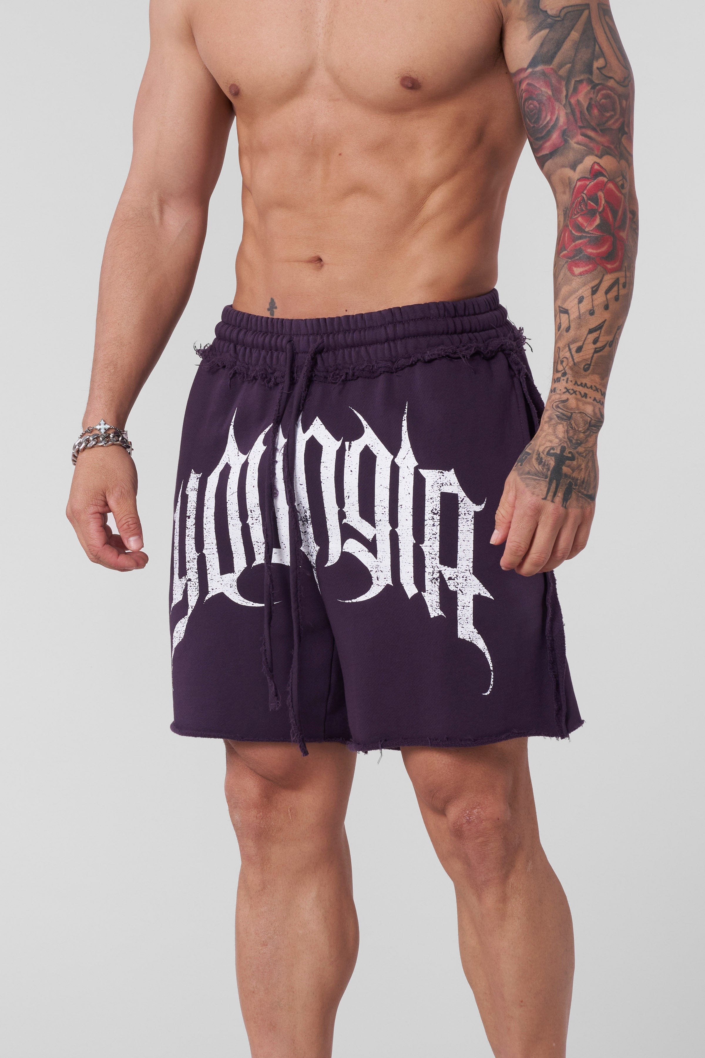 Model wearing loose cotton gym shorts while stretching outdoors