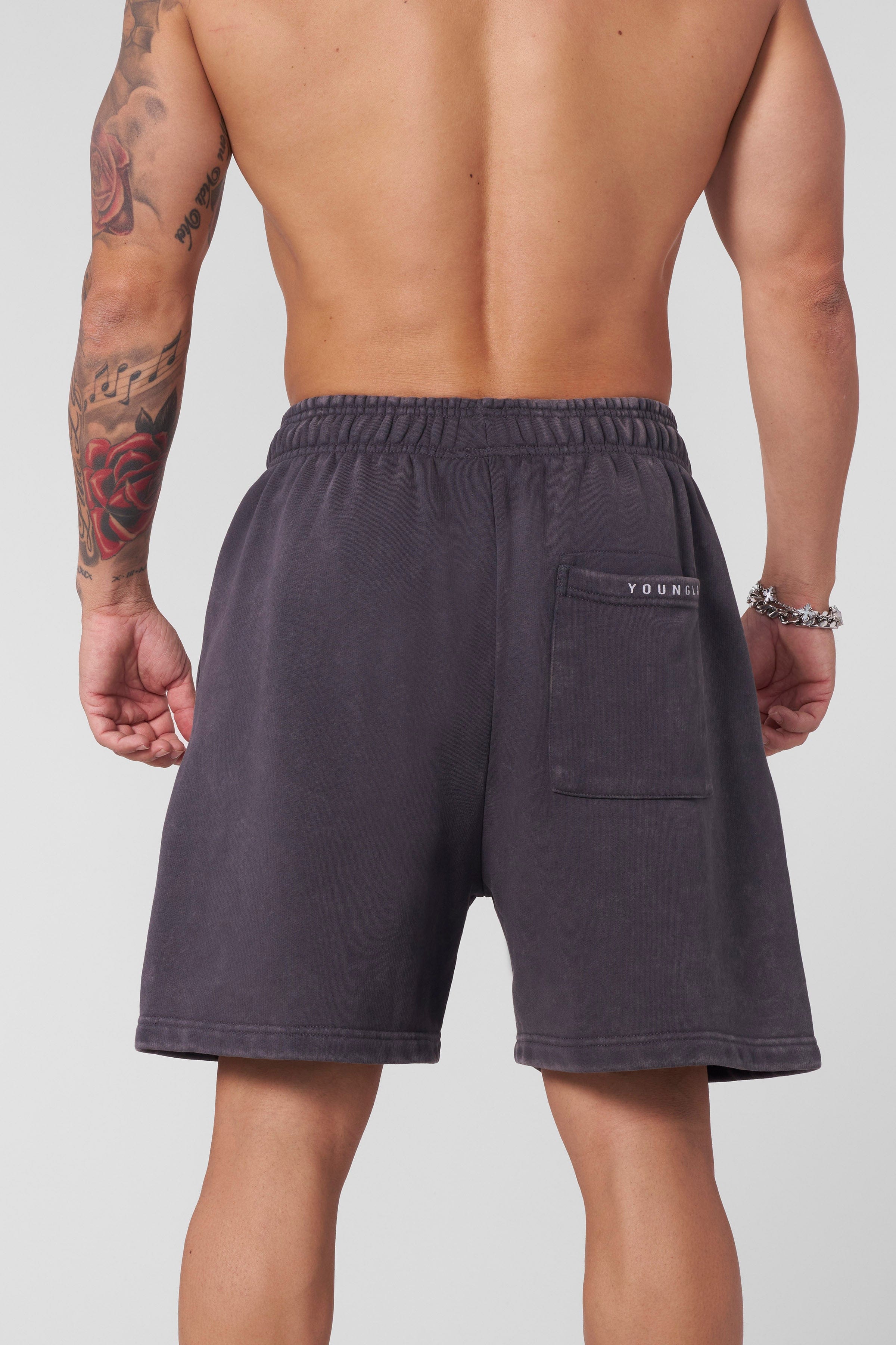 Side view of model wearing relaxed cotton shorts in summer.