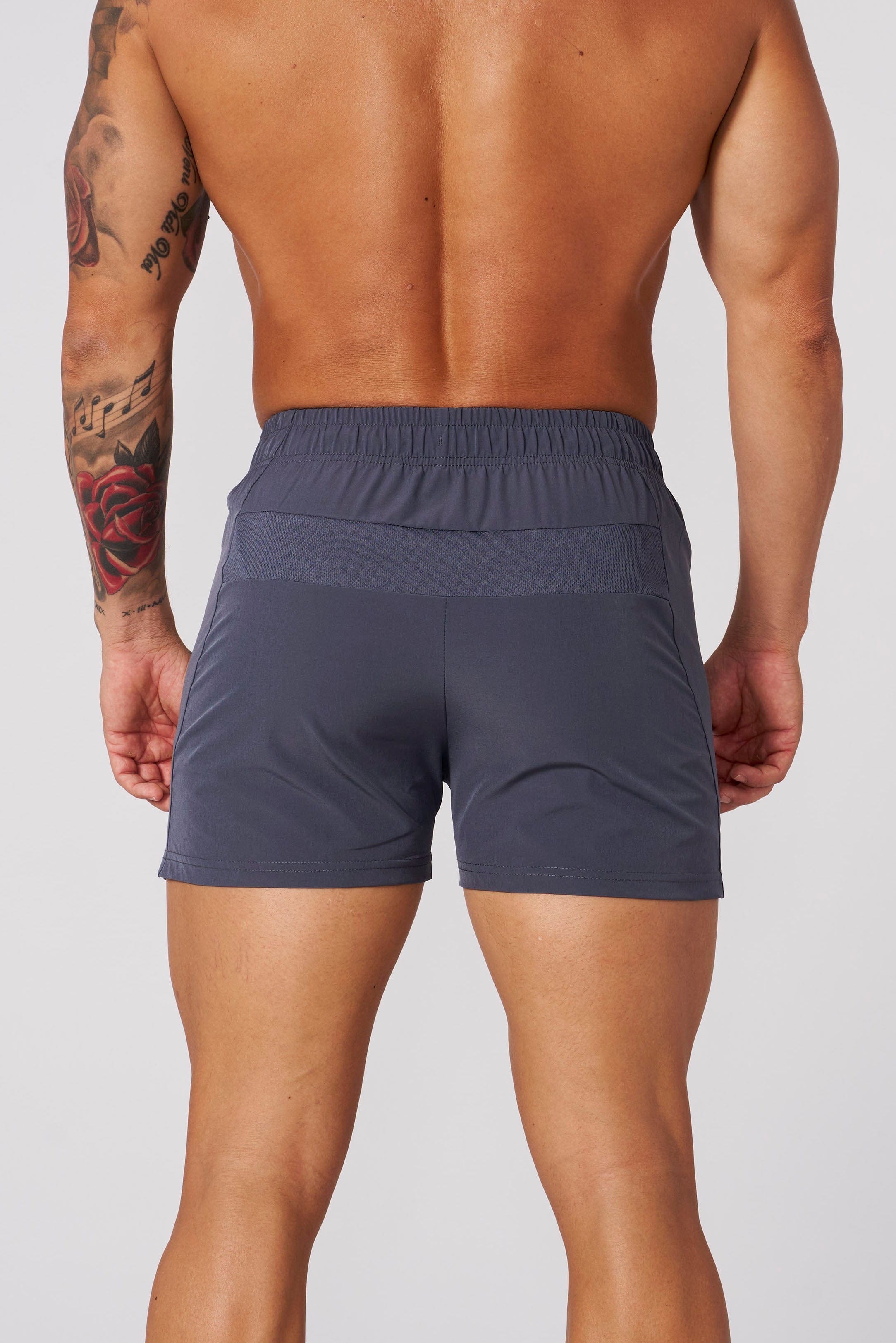 Side angle of mens workout shorts emphasizing quad muscle fit