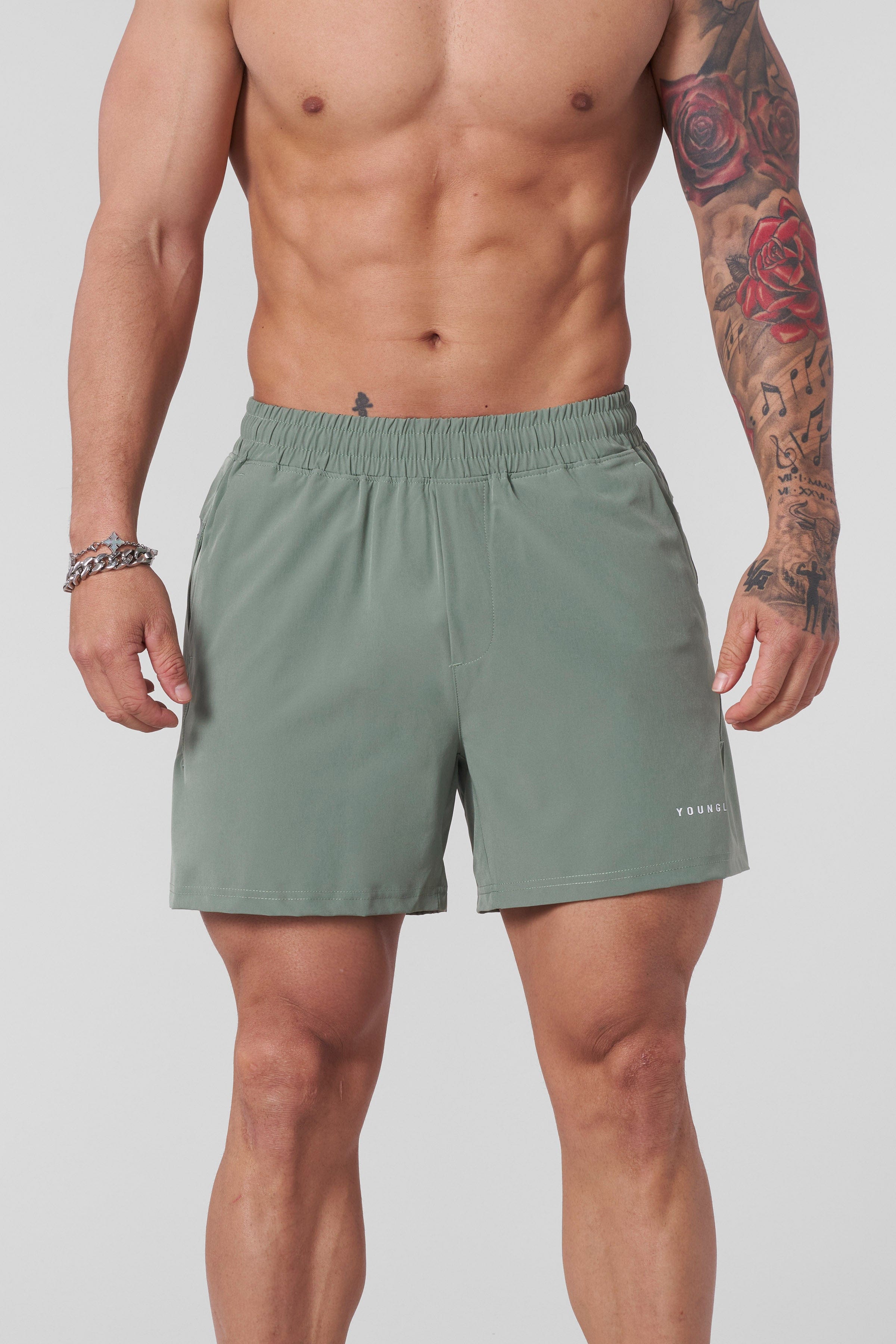 Top-down view showing elastic waistband and logo detail on gym shorts men