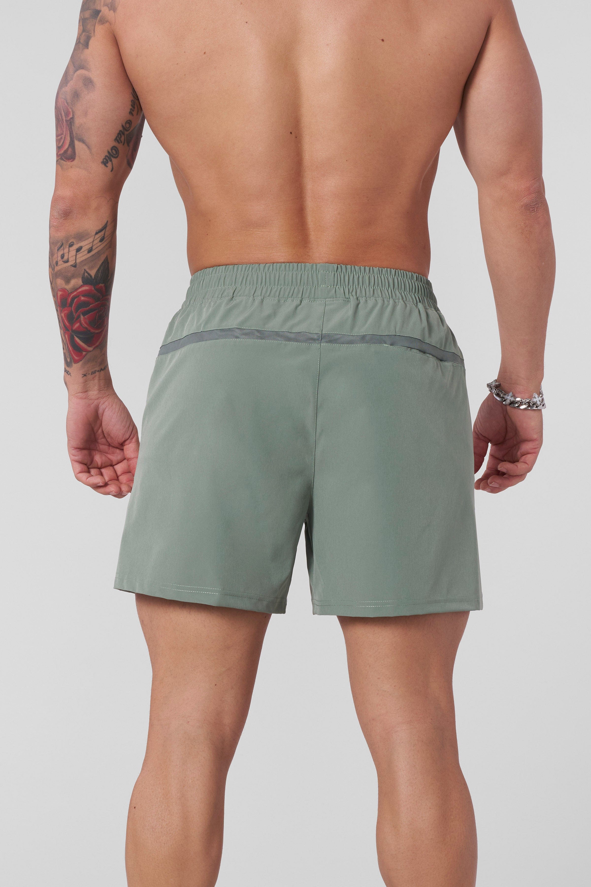 Side angle of model performing lunges wearing lightweight workout shorts