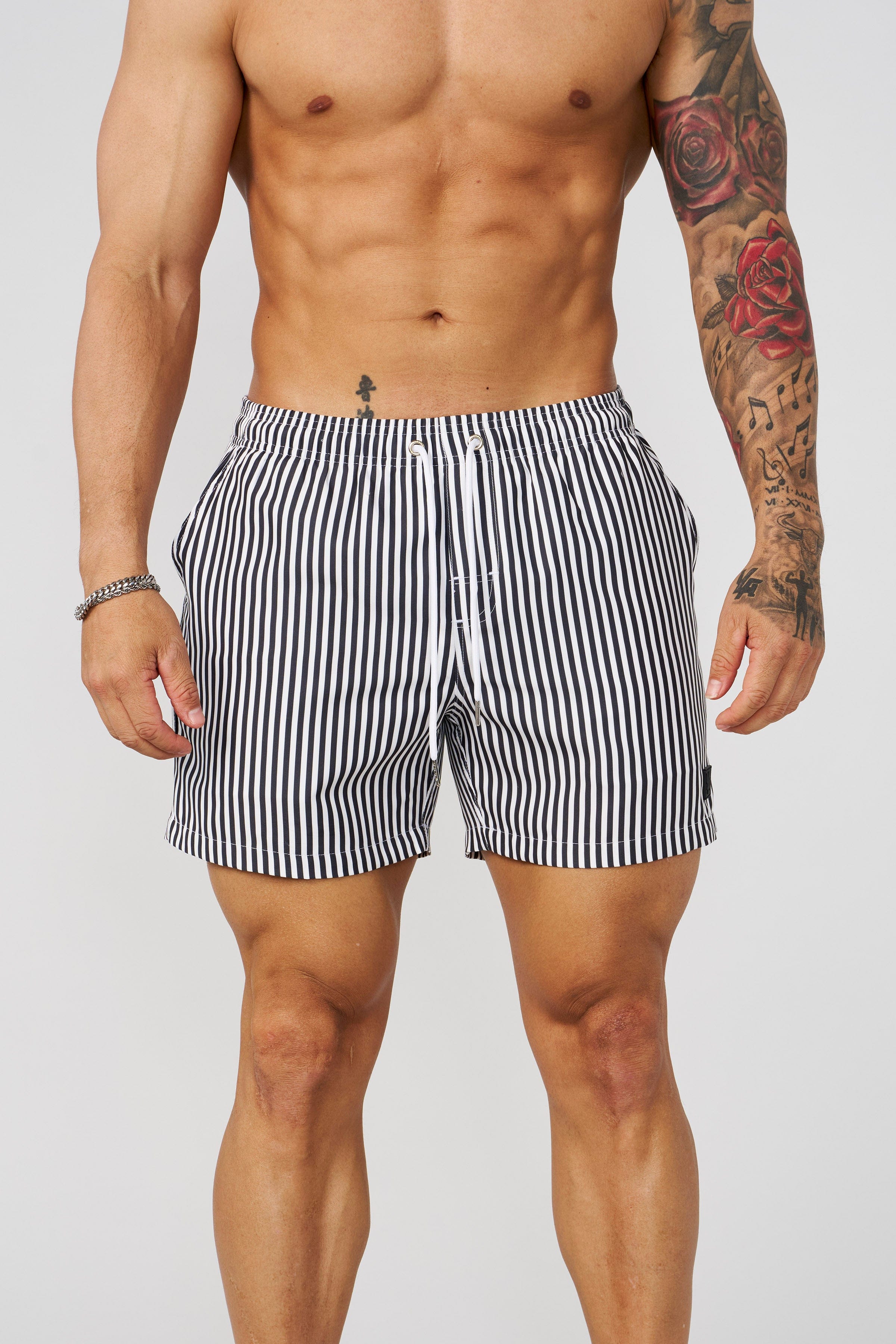 Close-up of the fabric and striped design of mens swim trunks short