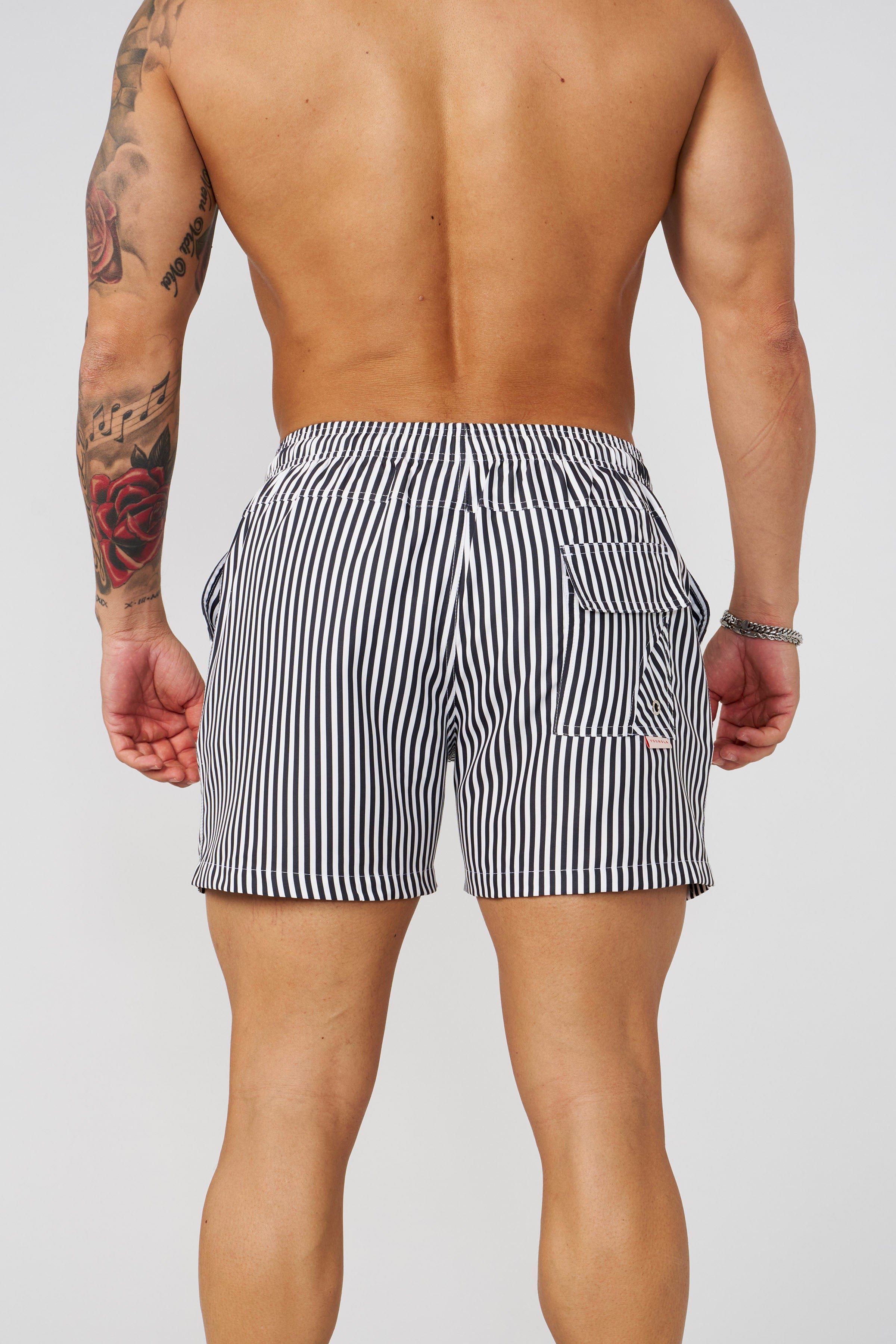 Close-up of the fabric and striped design of mens swim trunks short
