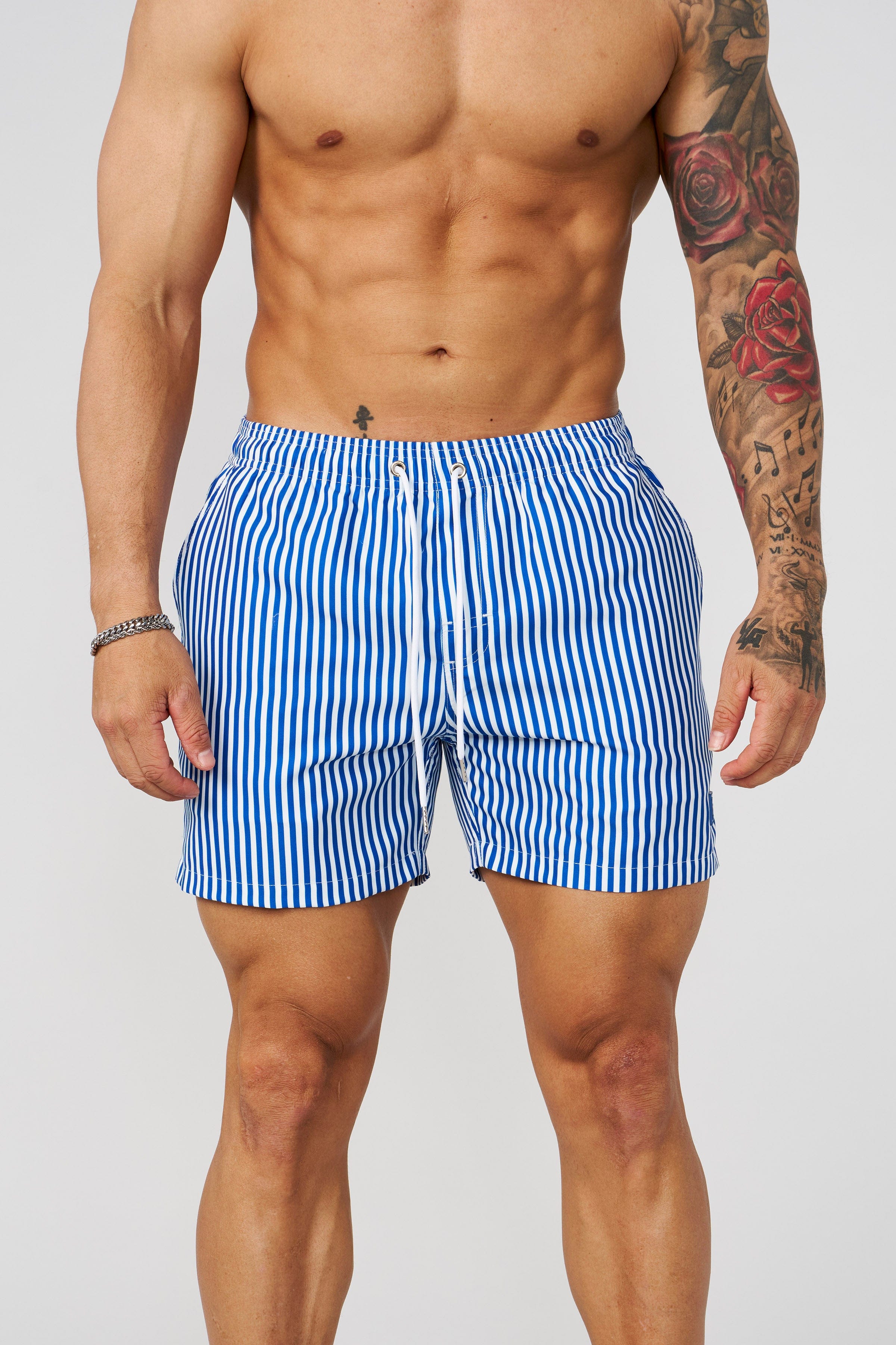 Men wearing striped swim shorts at the poolside, summer style