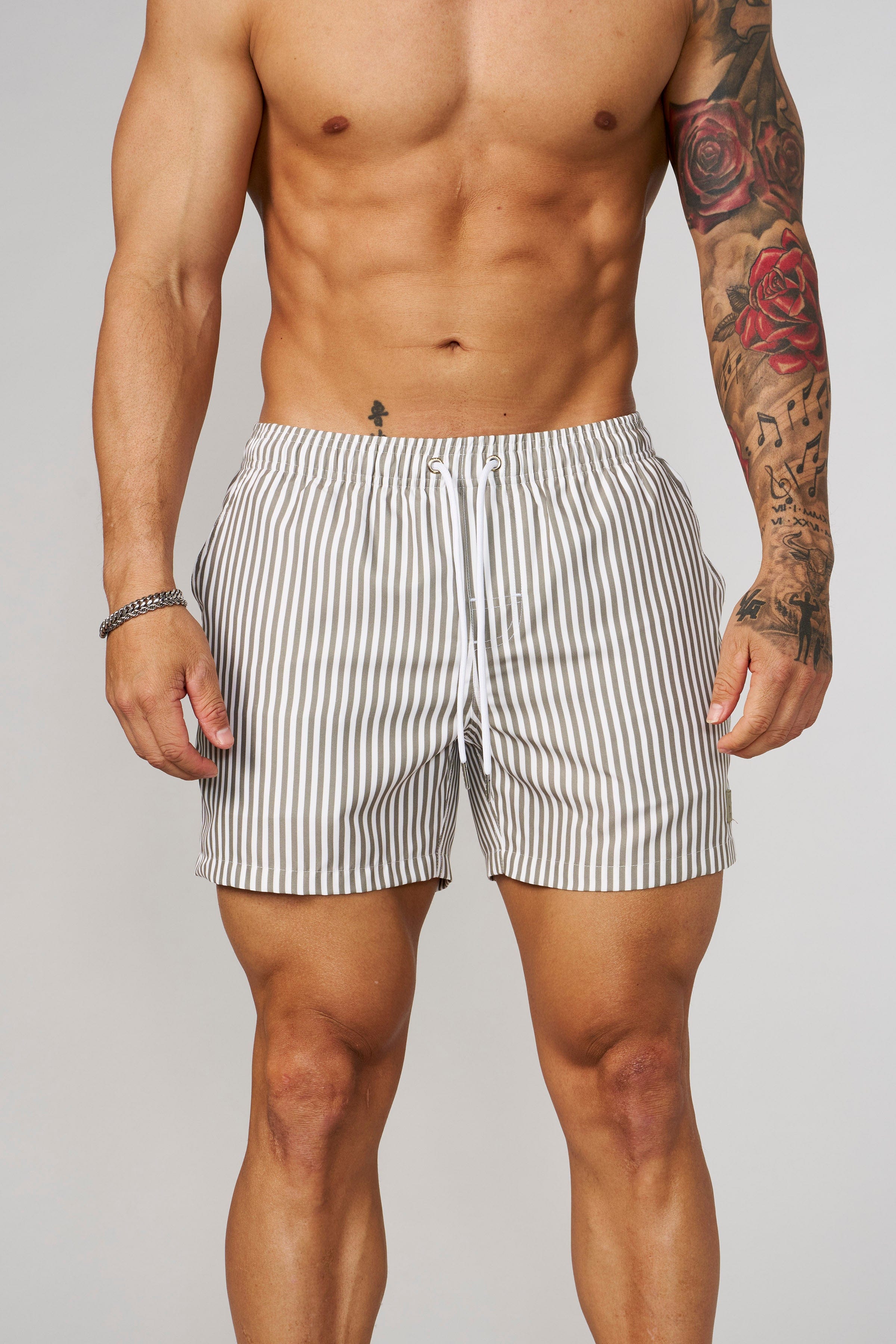 Front view of striped swim shorts with vibrant pattern for beachwear