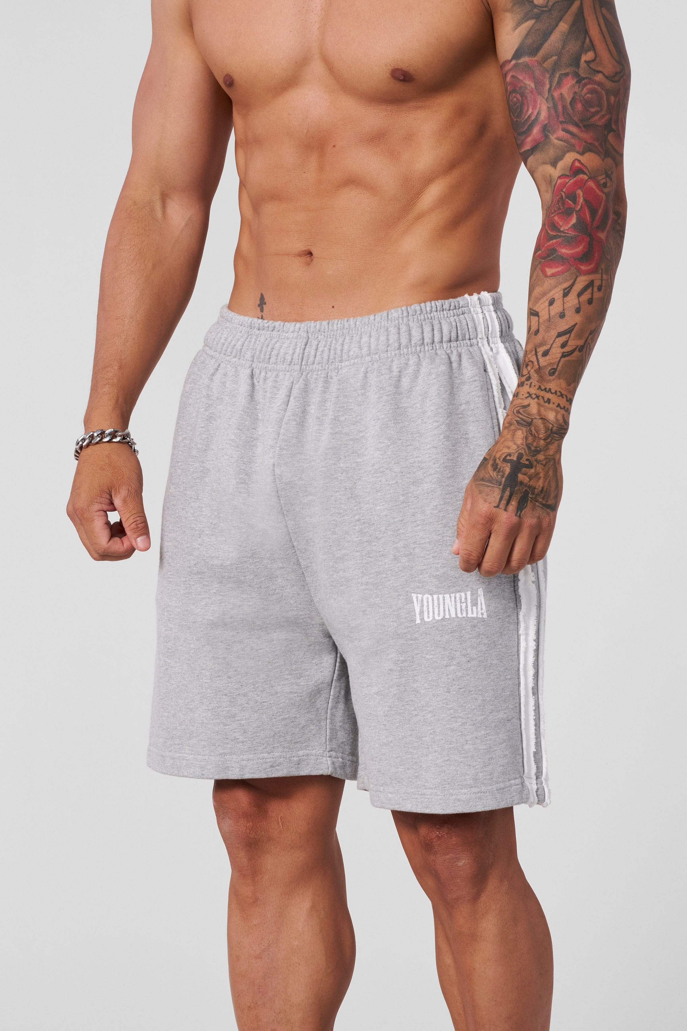 Model wearing striped sweat shorts, ideal for casual outings or workouts.