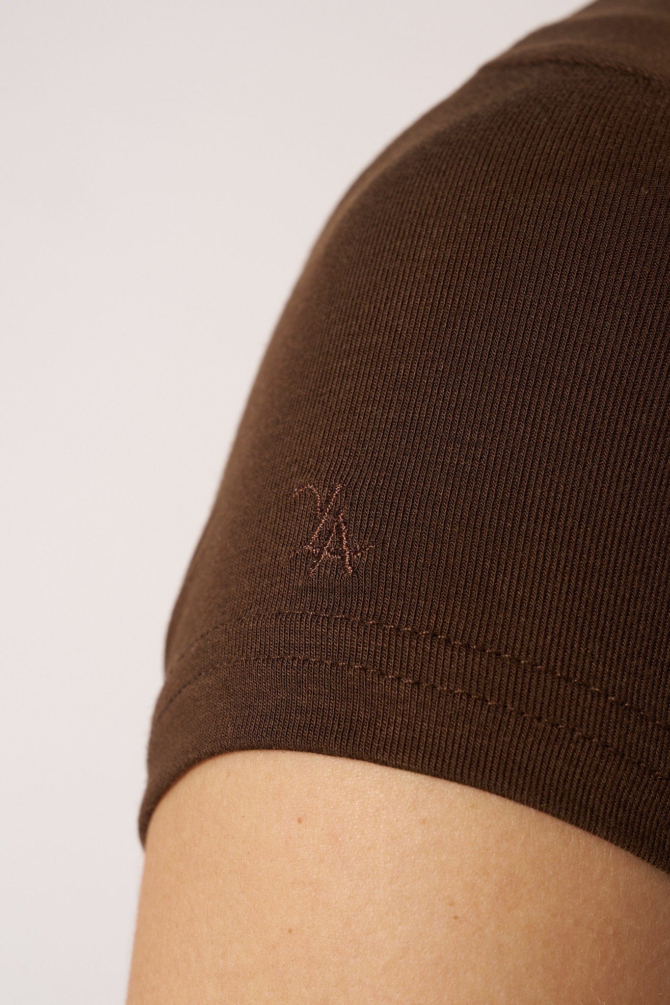 Close-up of the fabric texture of the snug fit t shirts, highlighting its stretchiness.