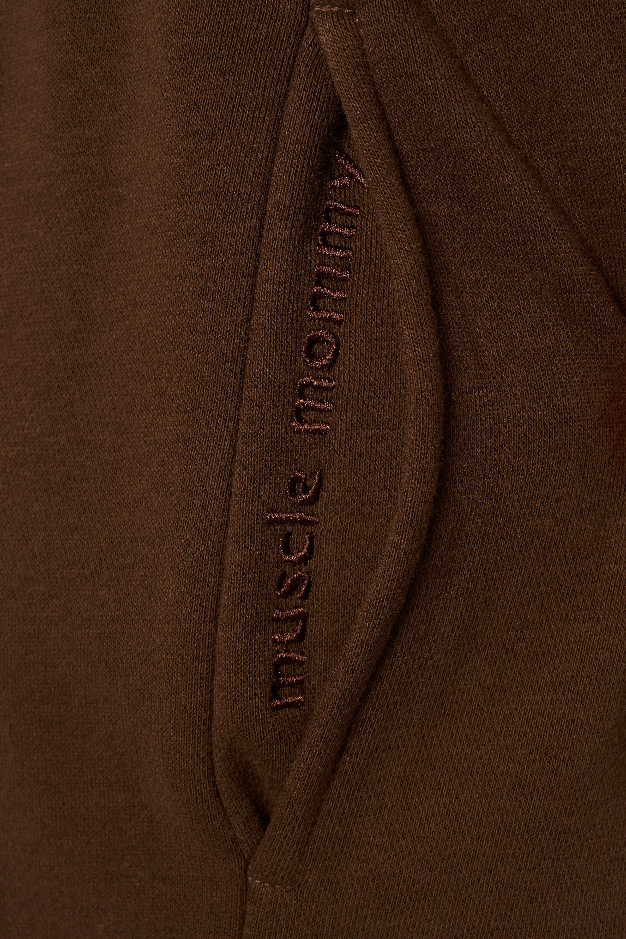 Close-up of hidden quote inside pocket of joggers, adding a personal touch.