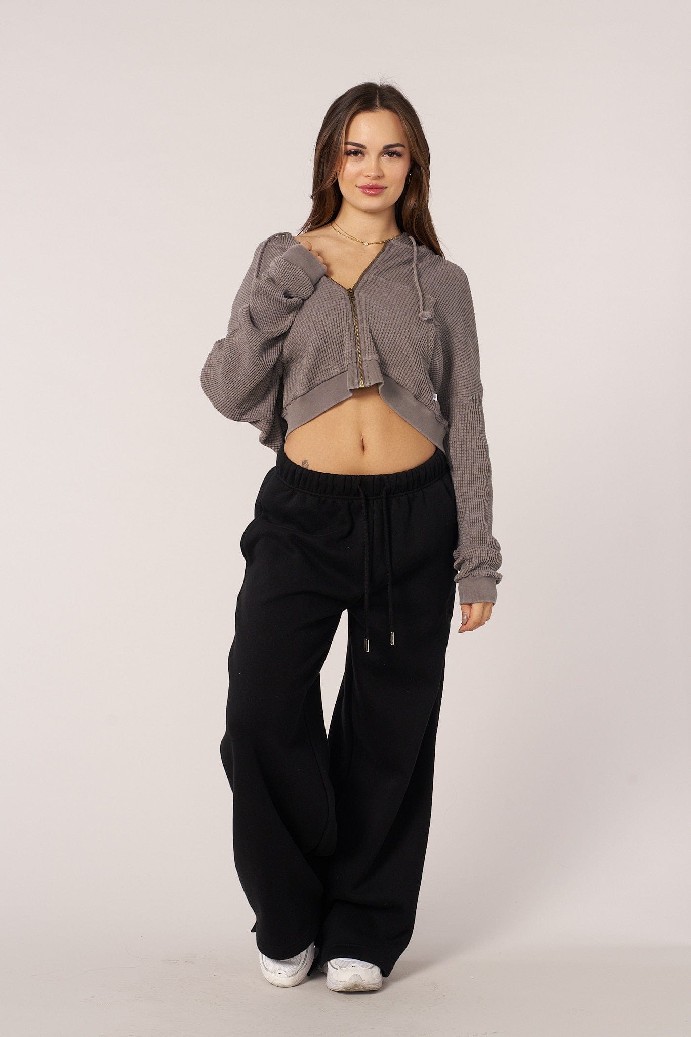 Cropped zip-up hoodie worn unzipped with white tee underneath