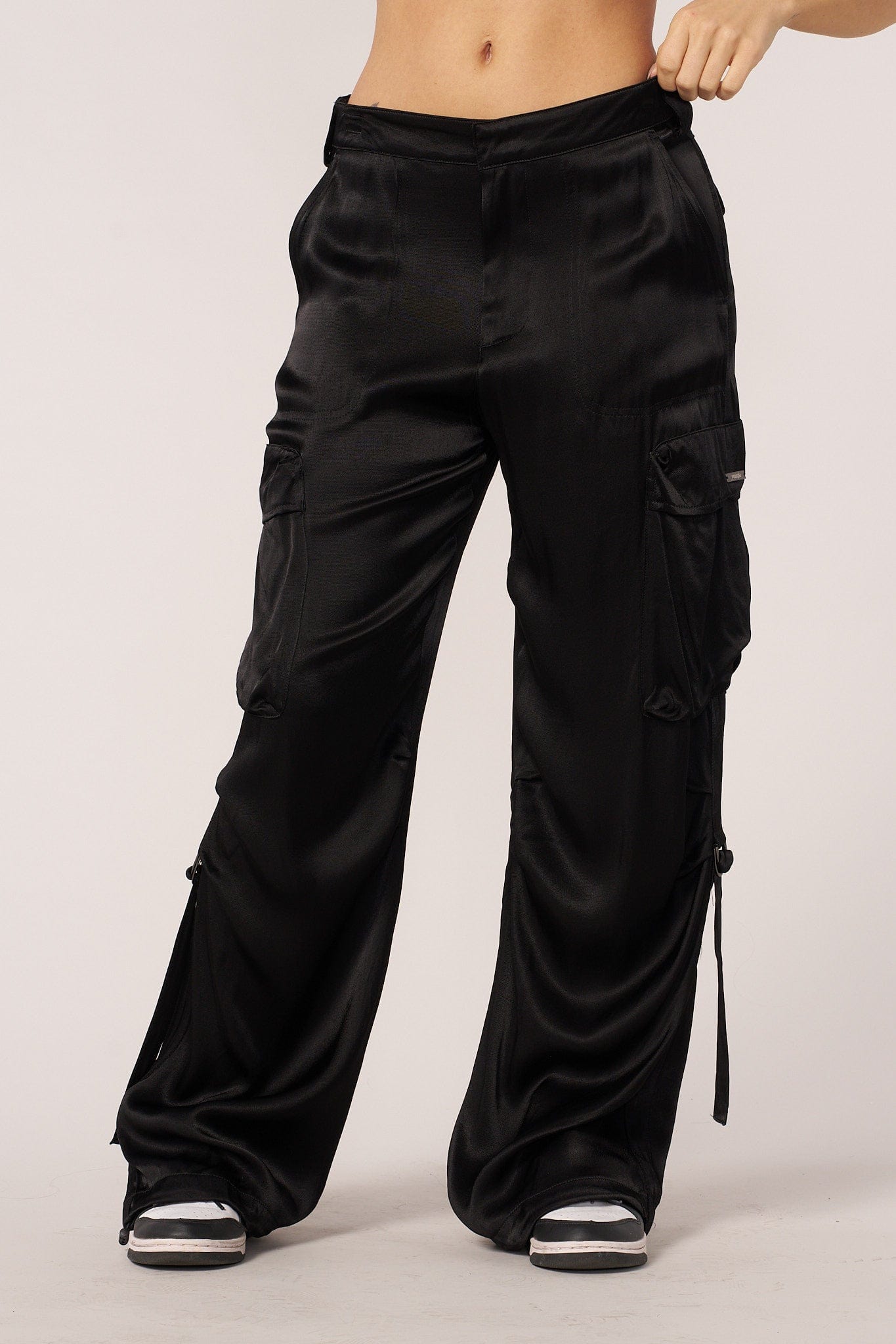 Close-up of satin cargo pant fabric texture and pocket styling