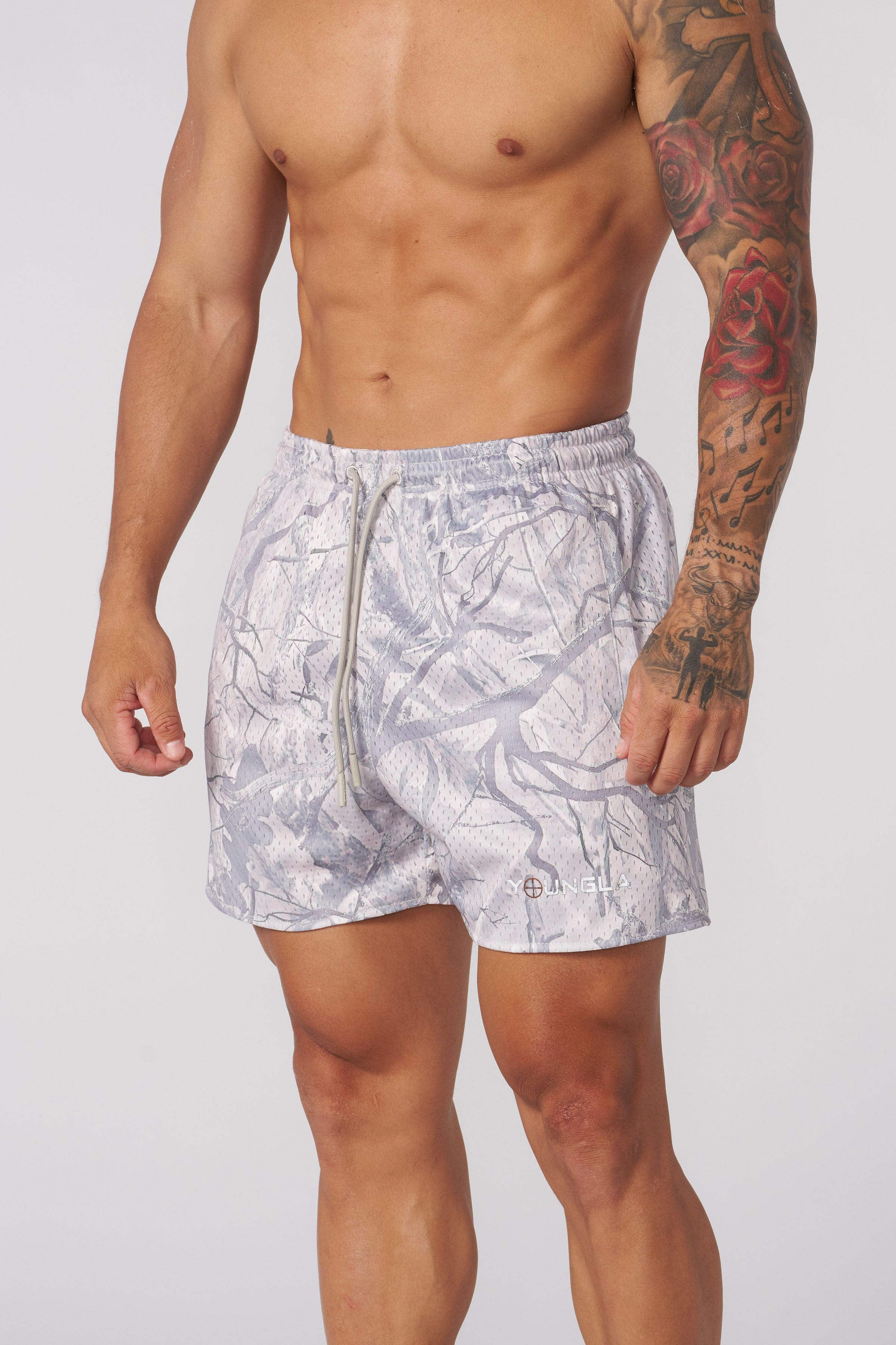 Athletic build wearing these camo cargo shorts during a workout session