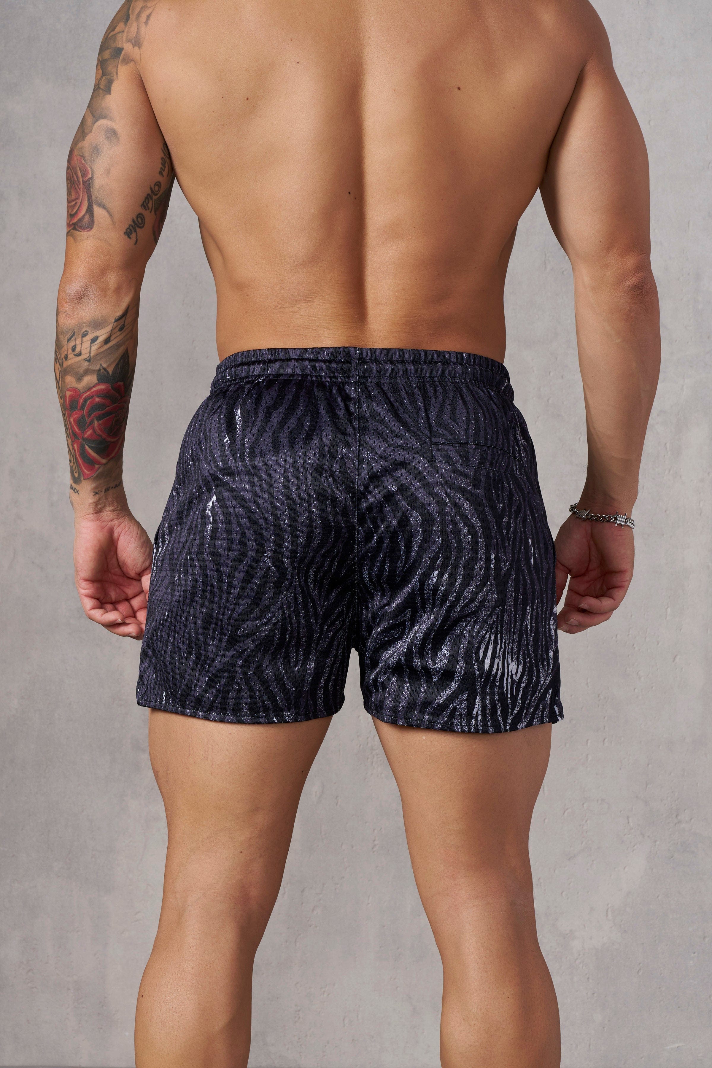 Model wearing reversible animal print shorts, demonstrating their comfortable fit.